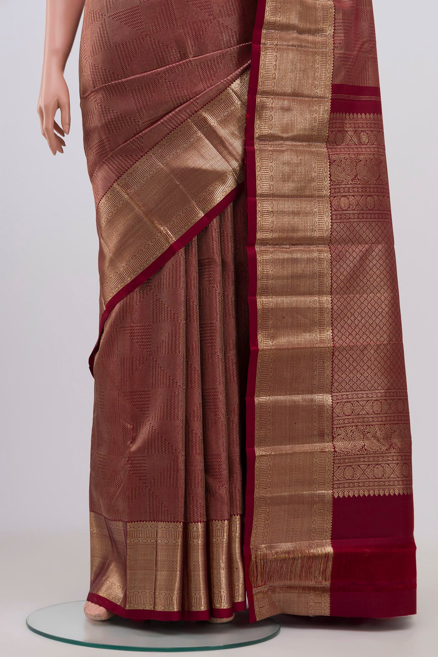 Pleats and pallu of Maroon Kanchipuram Silk Saree with Zari Brocade on the body and Zari Border. 