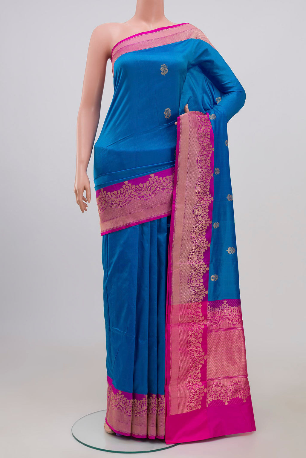 Blue Banarasi Katan Silk Saree with Zari Butta on the body and Zari Border.  displayed on a mannequin