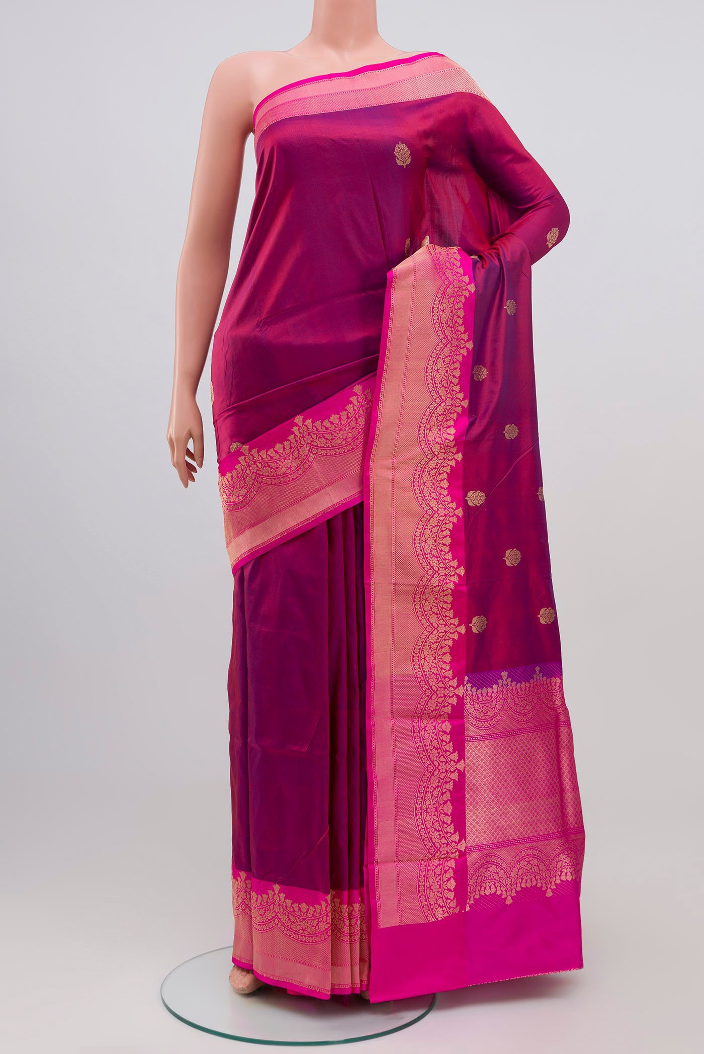 Maroon Banarasi Katan Silk Saree with Zari Butta on the body and Zari Border.  displayed on a mannequin