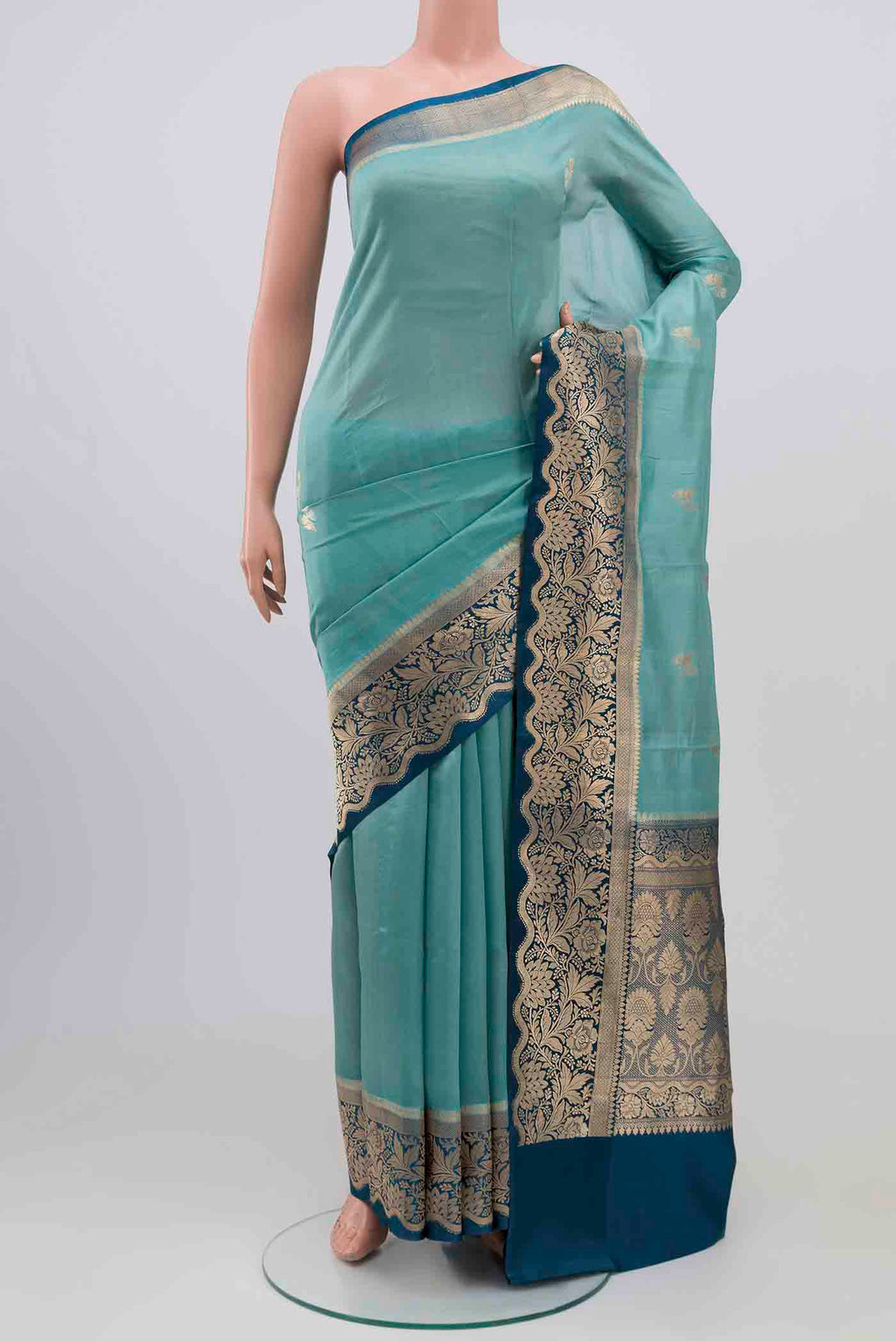 Sky Blue Banarasi Katan Silk Saree with Zari Butta on the body and Zari Border.  displayed on a mannequin