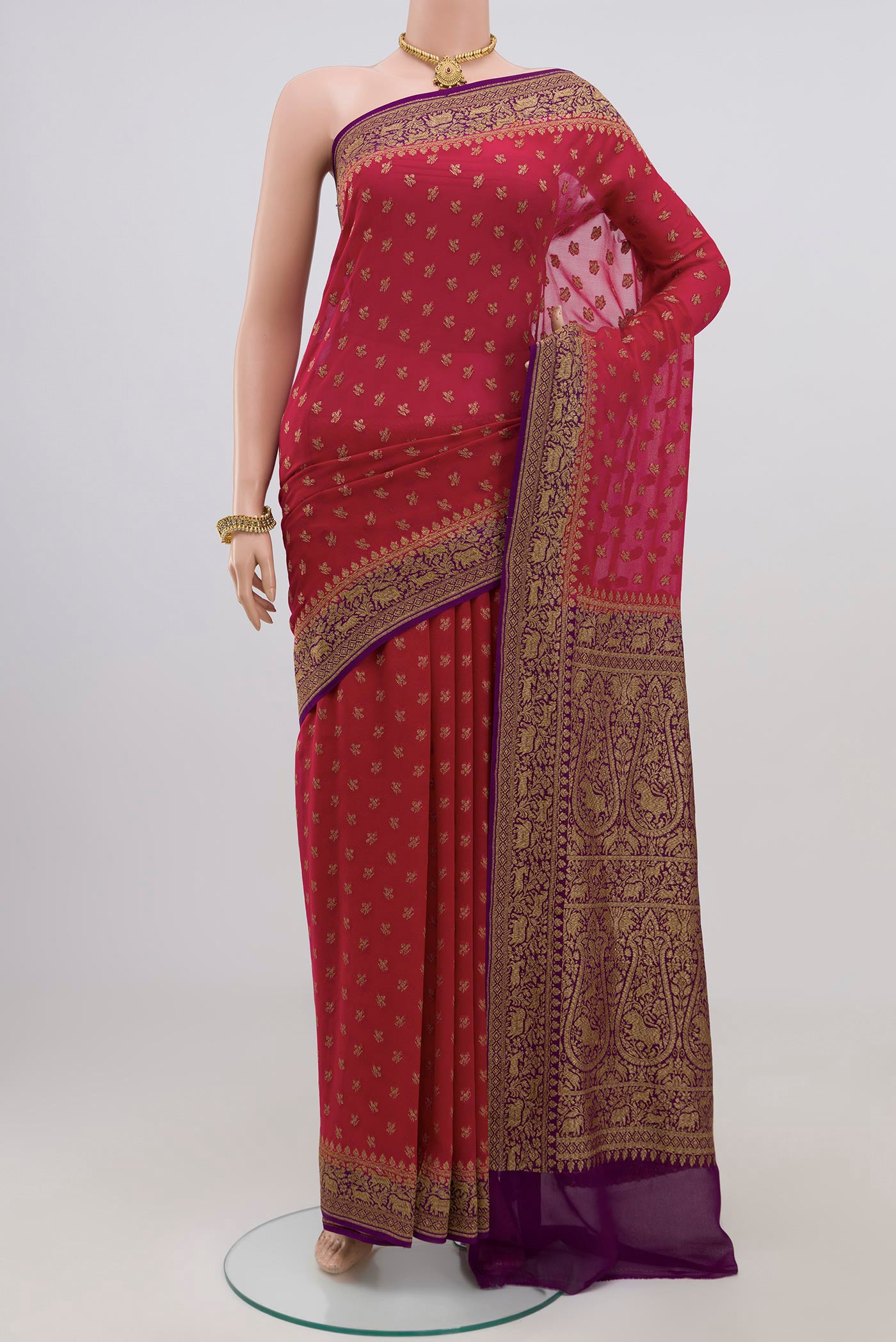 Red Georgette Saree with Fancy on the body and Zari Border.  displayed on a mannequin