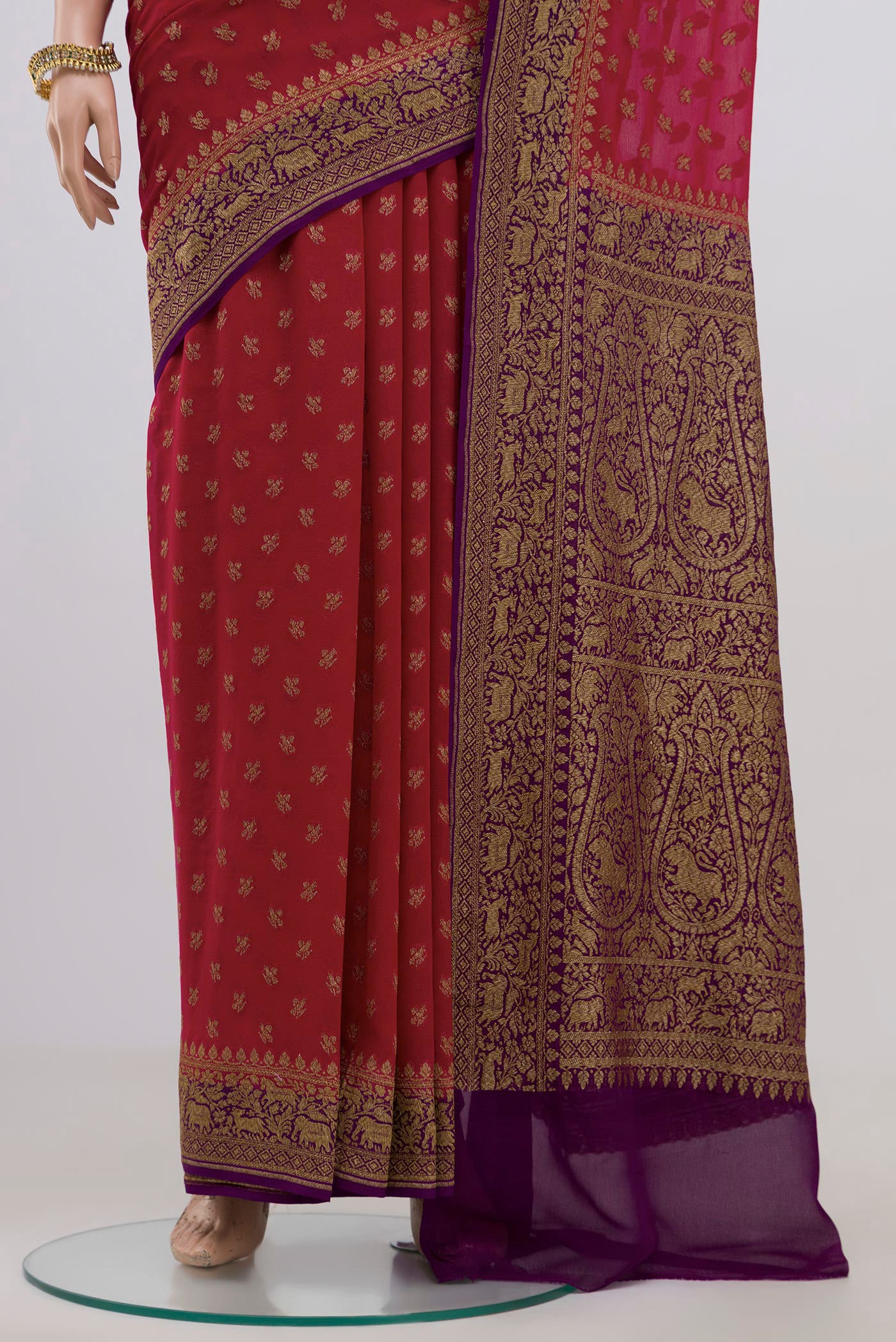 Pleats and pallu of Red Georgette Saree with Fancy on the body and Zari Border. 