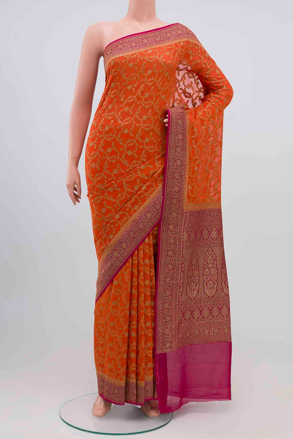 Orange Banarasi Georgette Saree with Zari Brocade on the body and Zari Border.  displayed on a mannequin