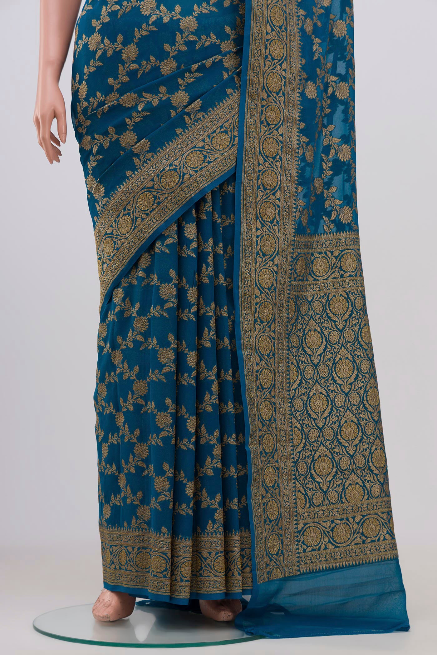 Pleats and pallu of Blue Banarasi Georgette Saree with Fancy on the body and Zari Border. 