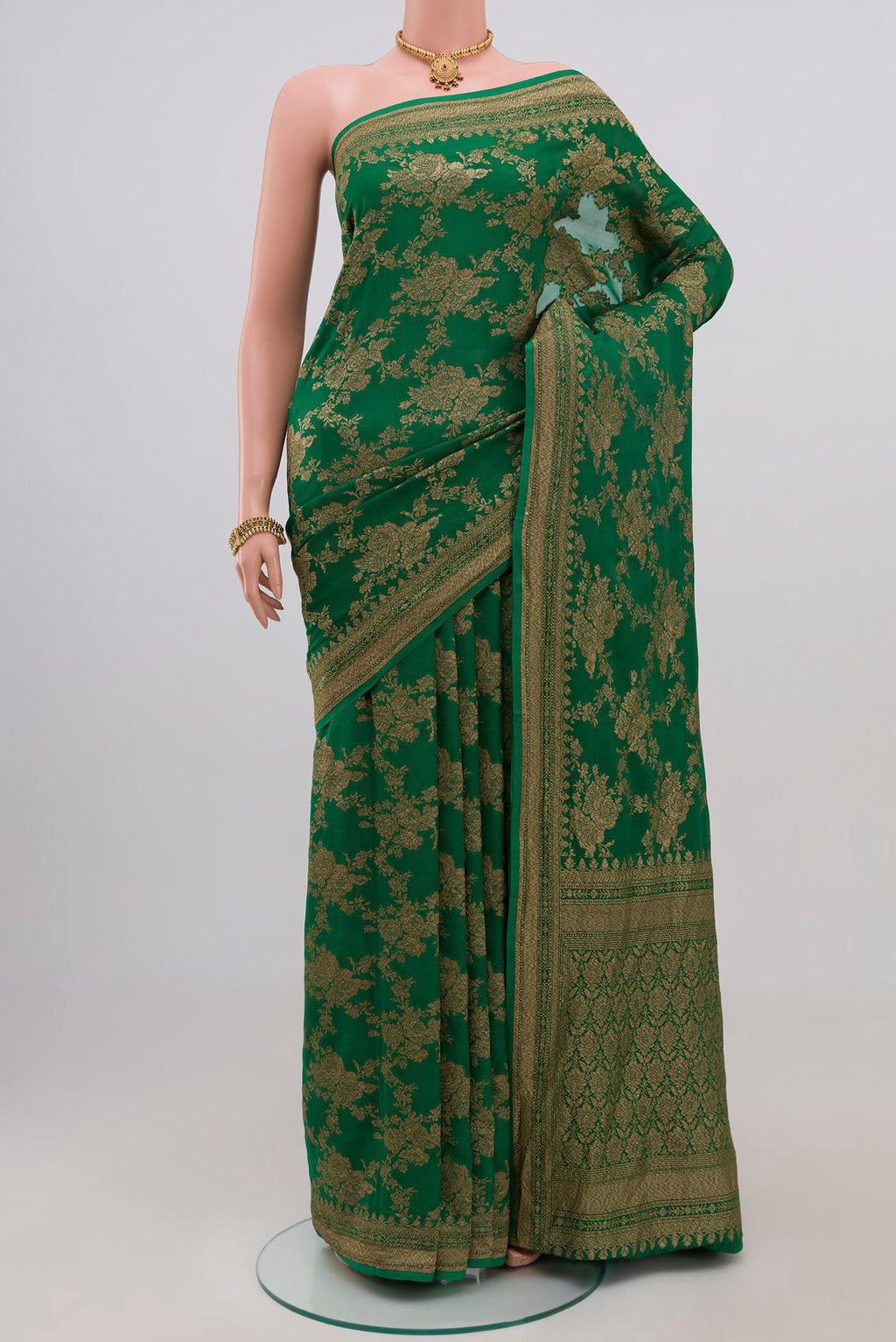 Green Georgette Saree with Fancy on the body and Zari Border.  displayed on a mannequin
