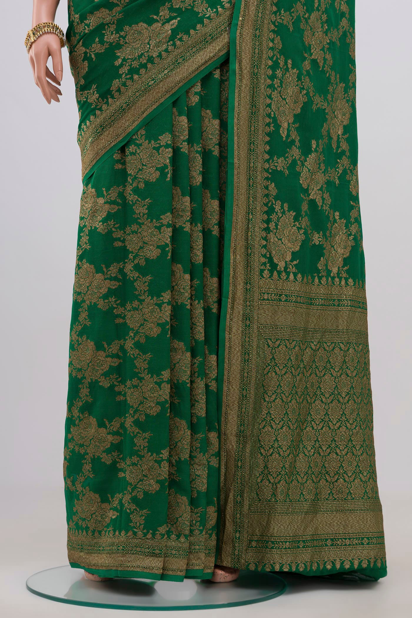 Pleats and pallu of Green Georgette Saree with Fancy on the body and Zari Border. 