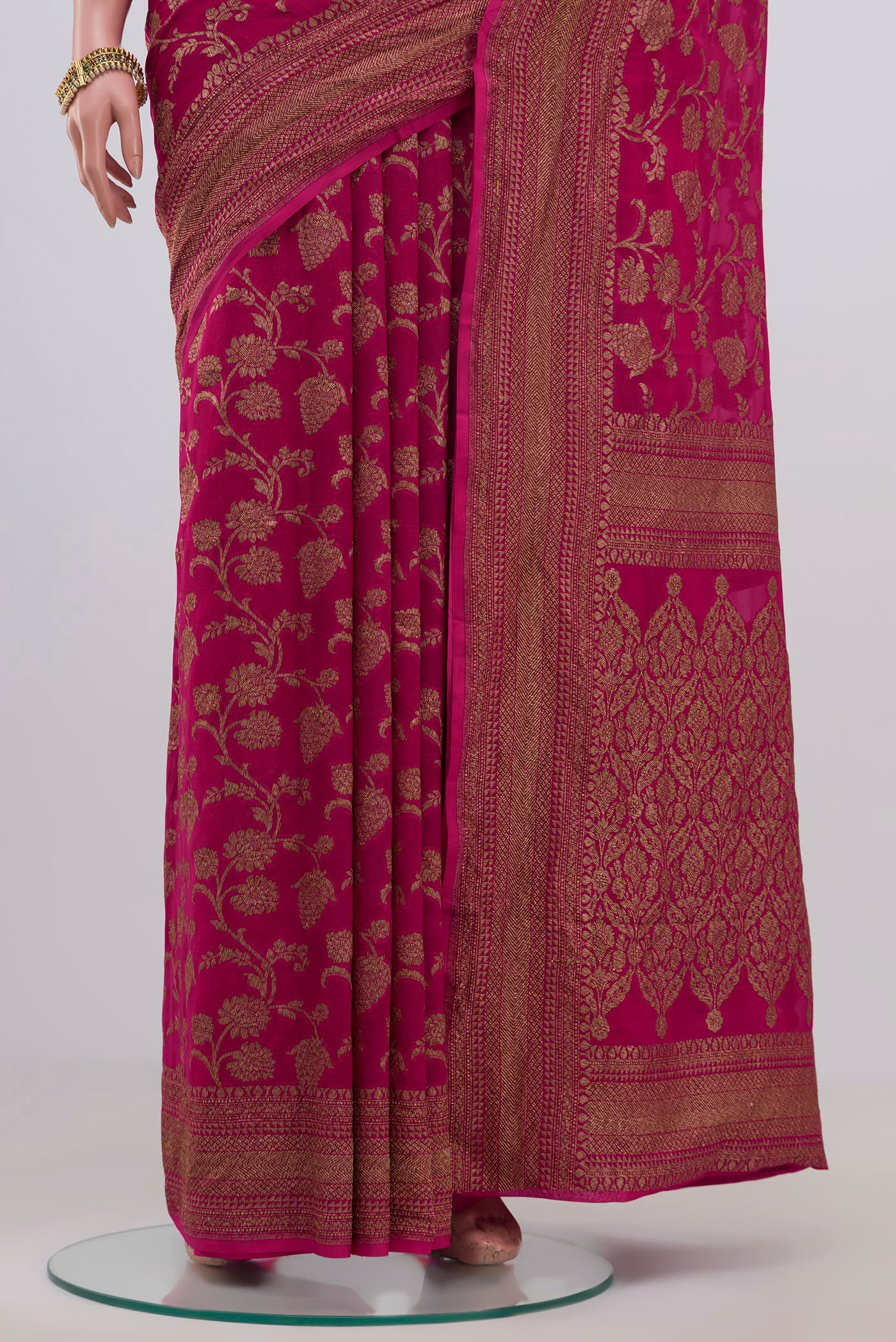 Pleats and pallu of Pink Georgette Saree with Fancy on the body and Zari Border. 