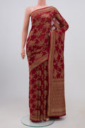 Maroon Georgette Saree with Fancy on the body and Zari Border.  displayed on a mannequin