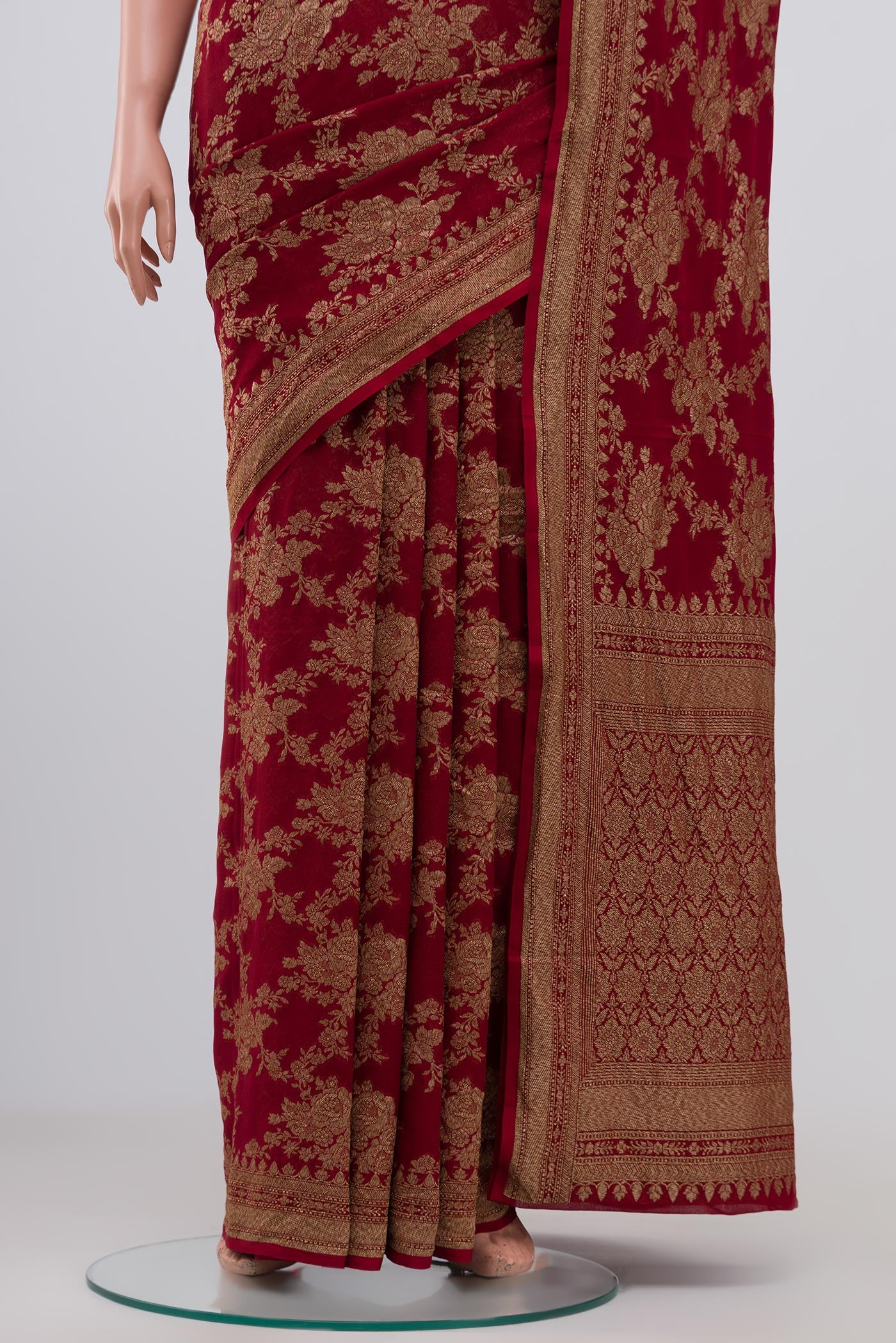 Pleats and pallu of Maroon Georgette Saree with Fancy on the body and Zari Border. 