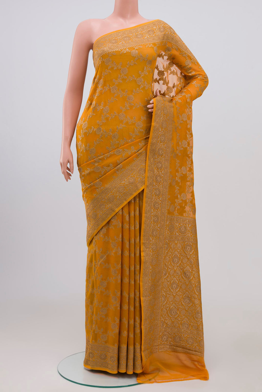 Yellow Banarasi Georgette Saree with Fancy on the body and Zari Border.  displayed on a mannequin