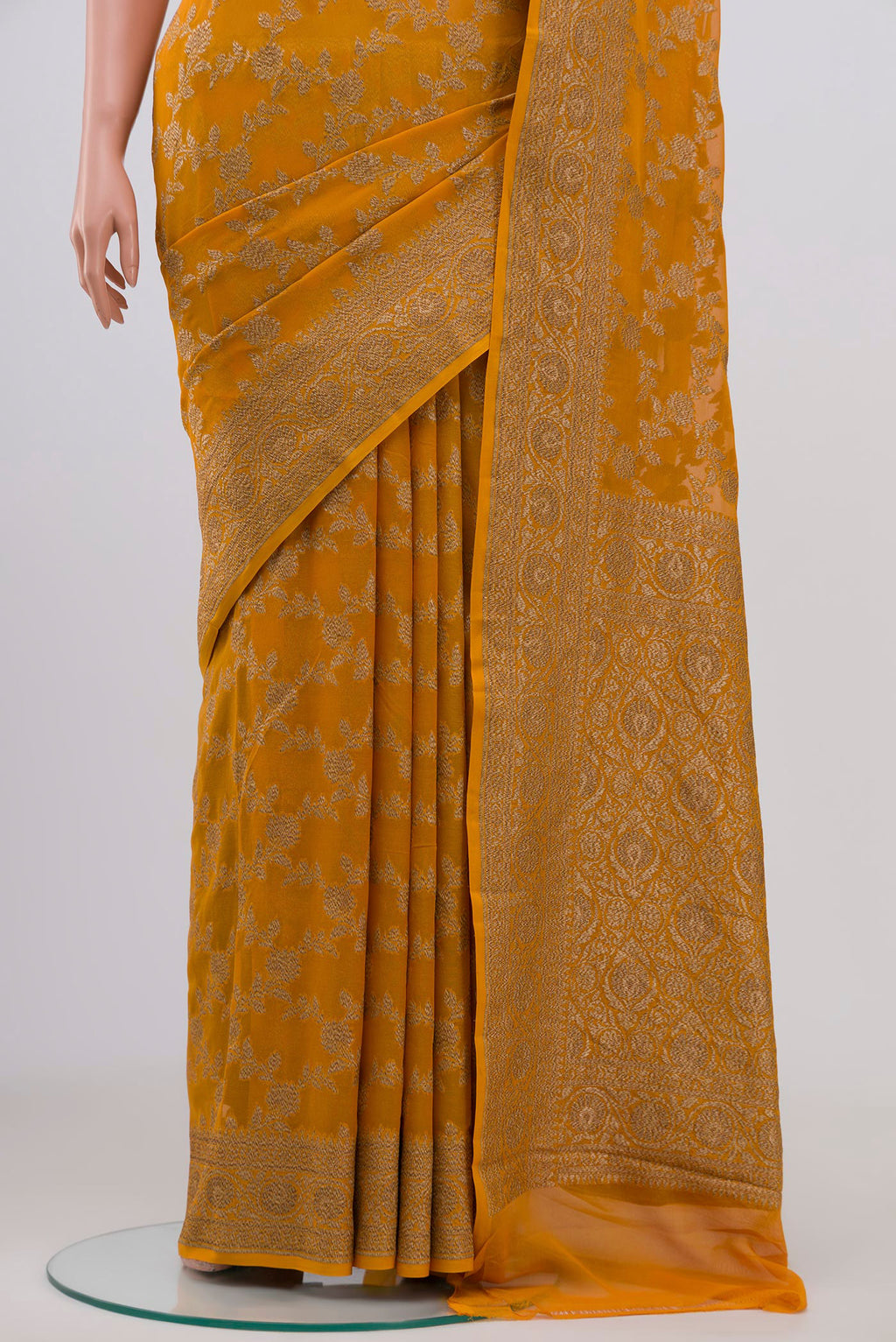 Pleats and pallu of Yellow Banarasi Georgette Saree with Fancy on the body and Zari Border. 