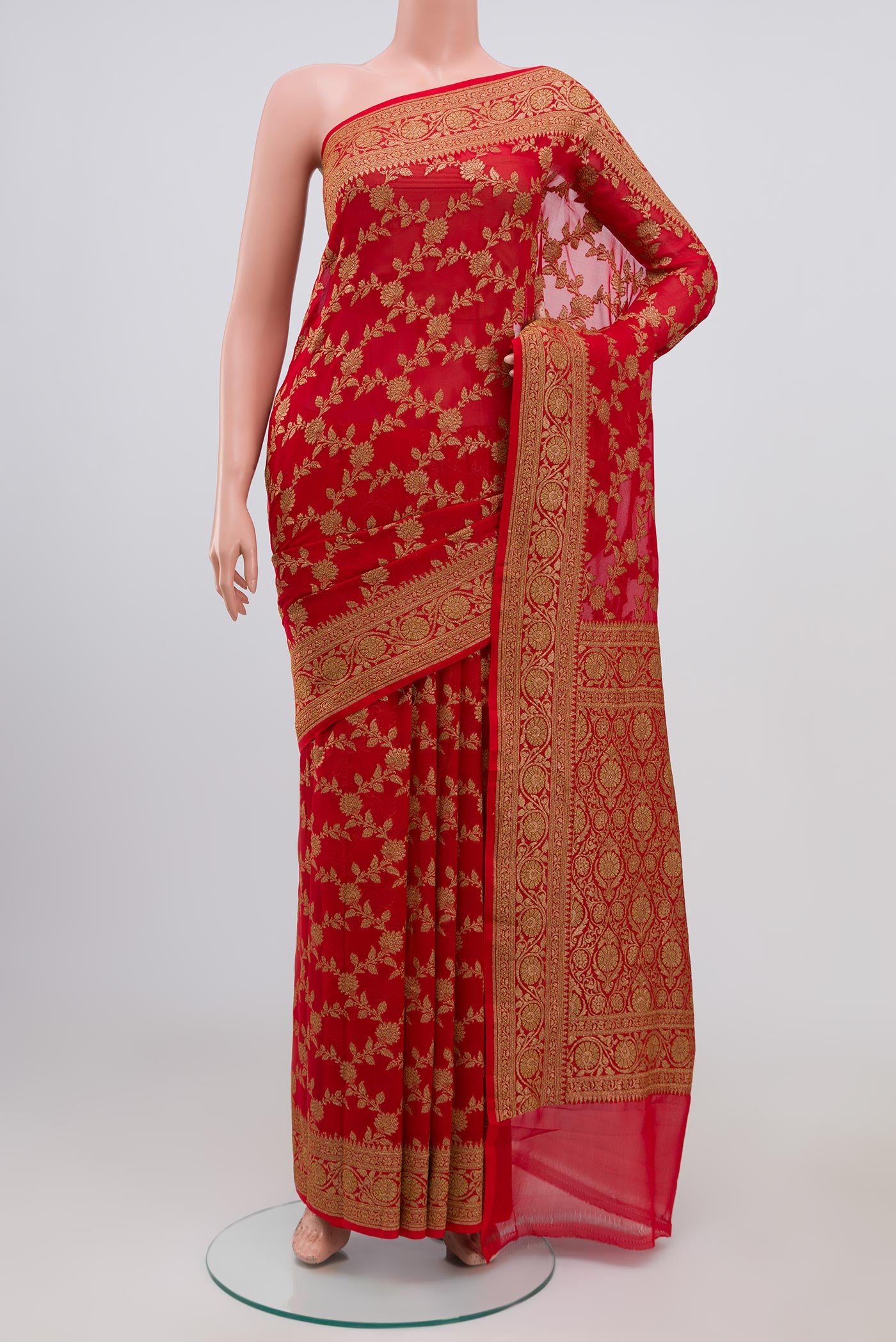 Red Georgette Saree with Fancy on the body and Zari Border.  displayed on a mannequin
