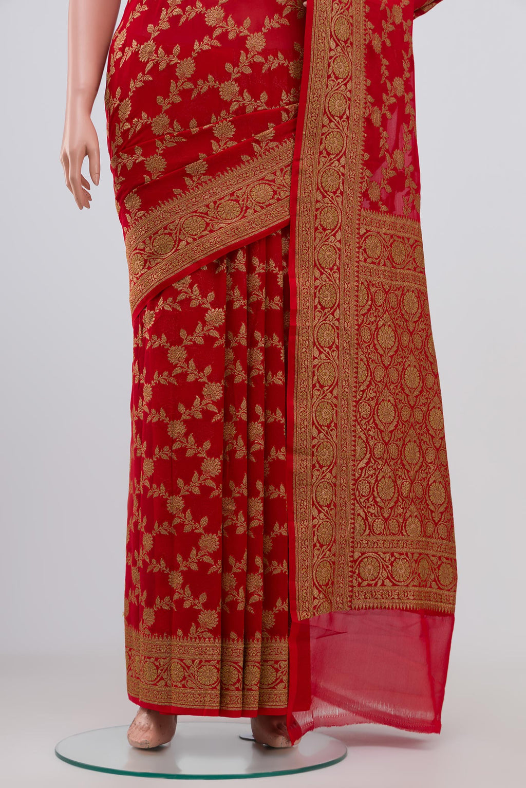 Pleats and pallu of Red Georgette Saree with Fancy on the body and Zari Border. 