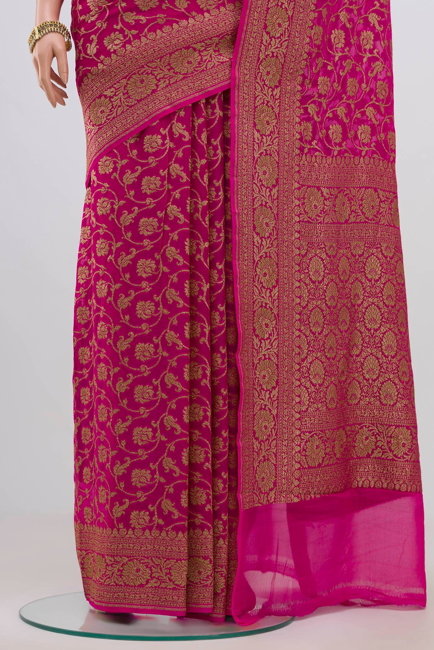Pleats and pallu of Pink Georgette Saree with Fancy on the body and Zari Border. 