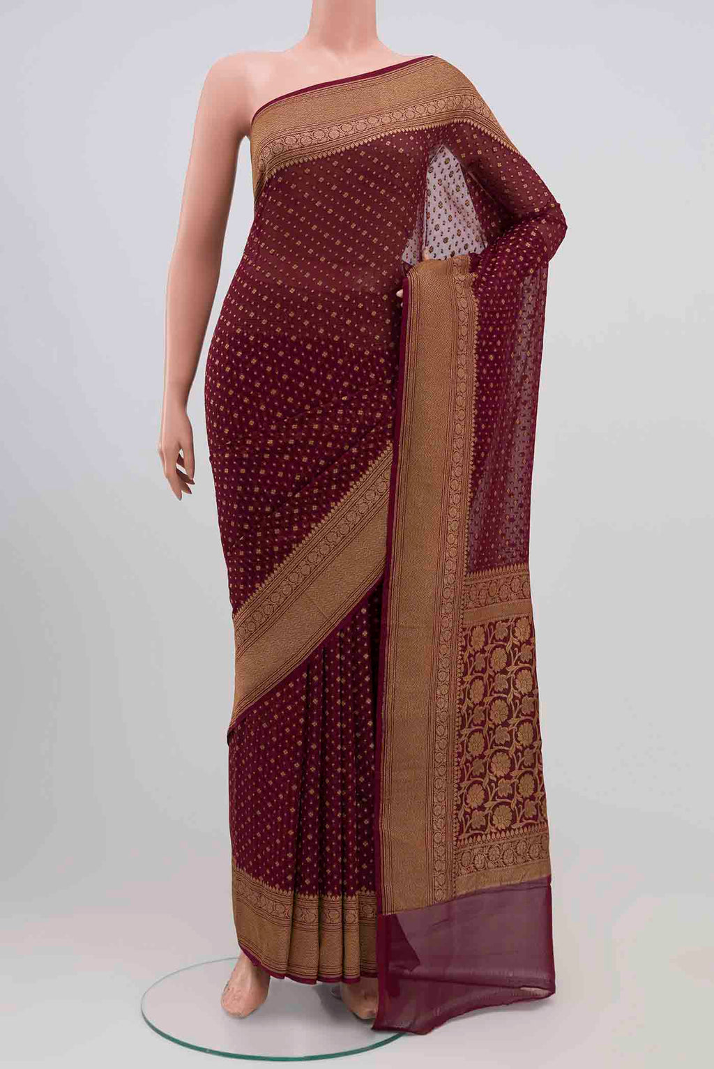 Maroon Banarasi Georgette Saree with Zari Brocade on the body and Zari Border.  displayed on a mannequin