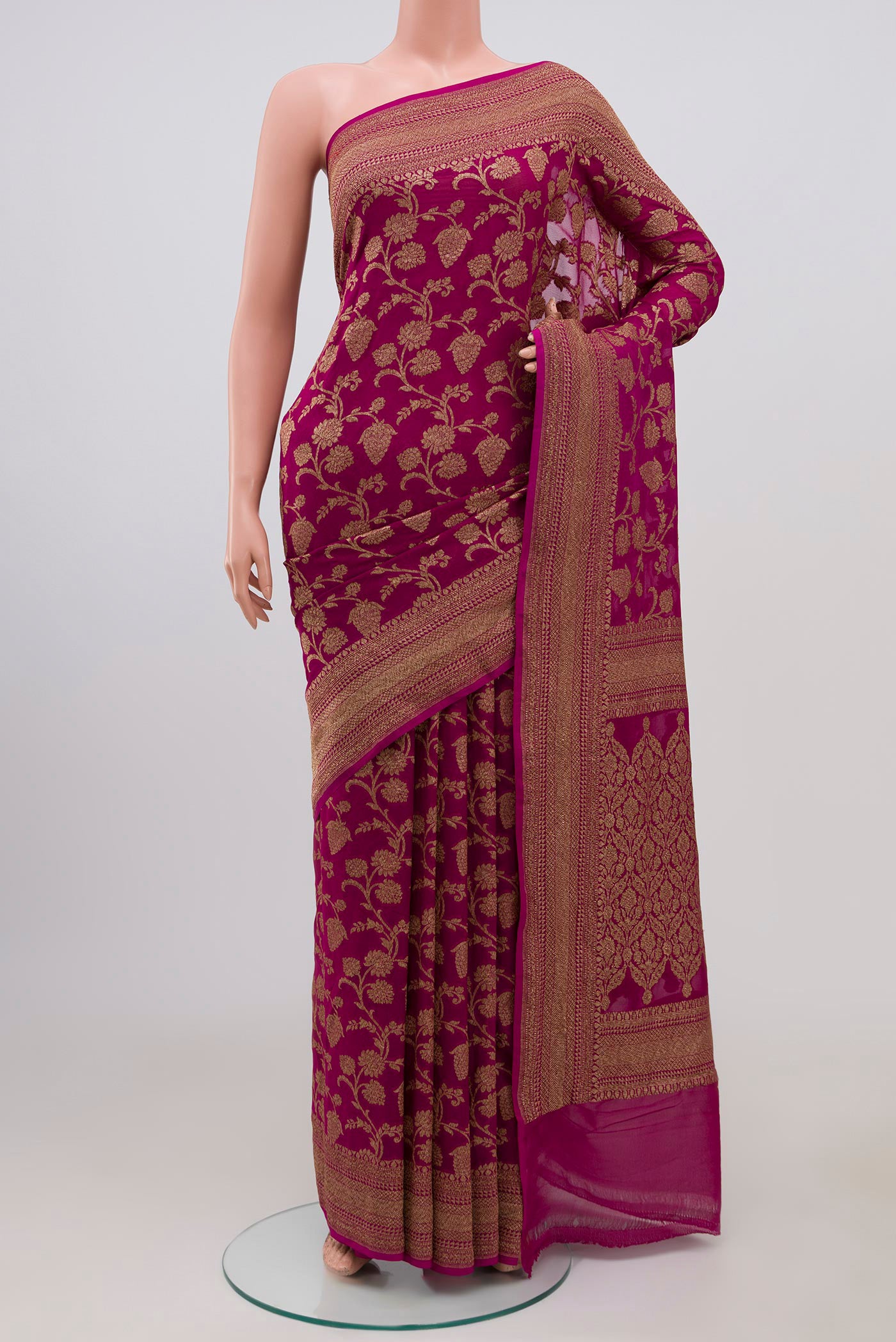 Magenta Georgette Saree with Fancy on the body and Zari Border.  displayed on a mannequin