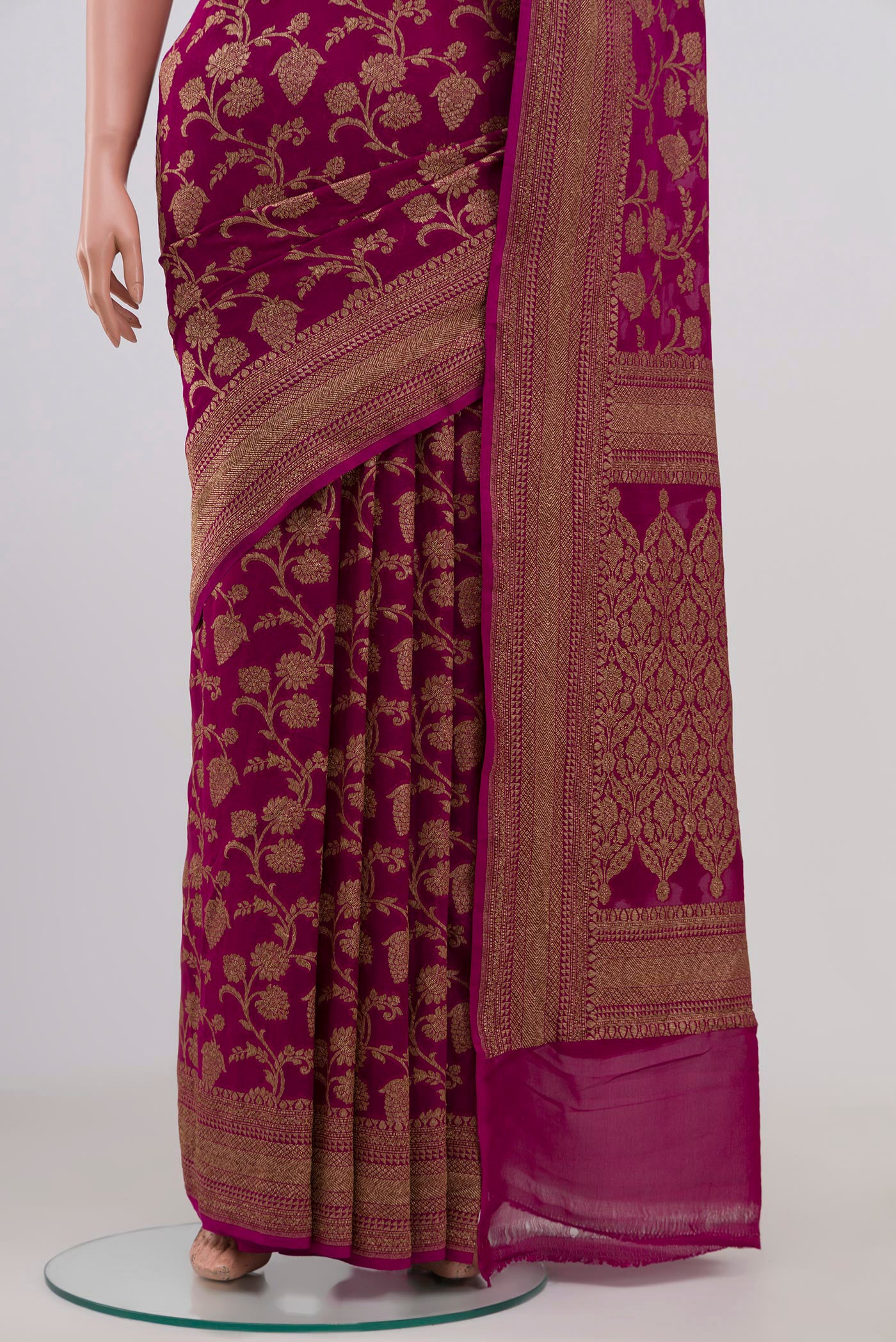 Pleats and pallu of Magenta Georgette Saree with Fancy on the body and Zari Border. 