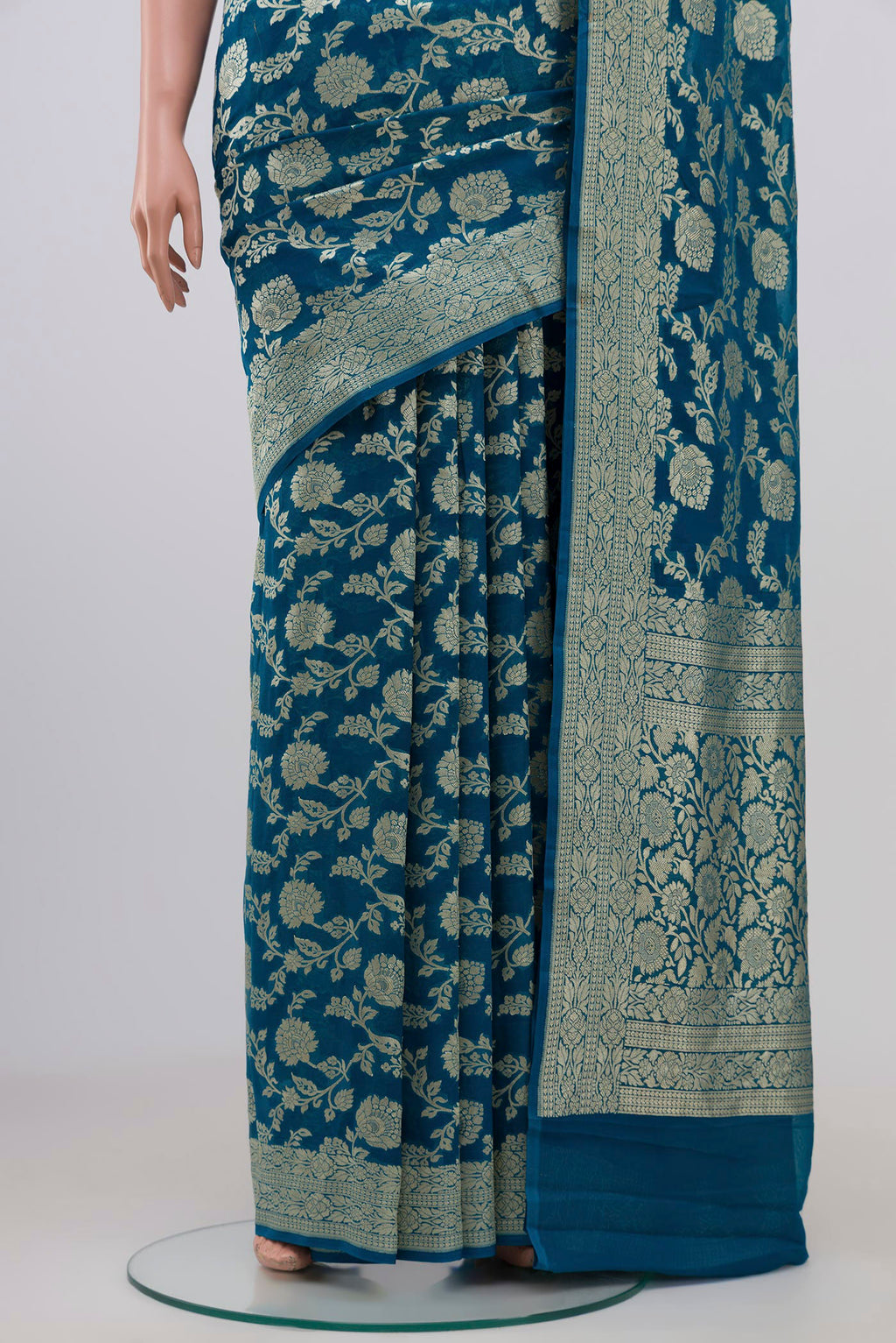 Pleats and pallu of Blue Georgette Saree with Fancy on the body and Zari Border. 