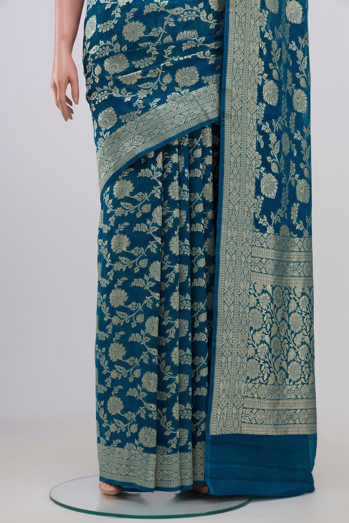 Pleats and pallu of Blue Georgette Saree with Fancy on the body and Zari Border. 
