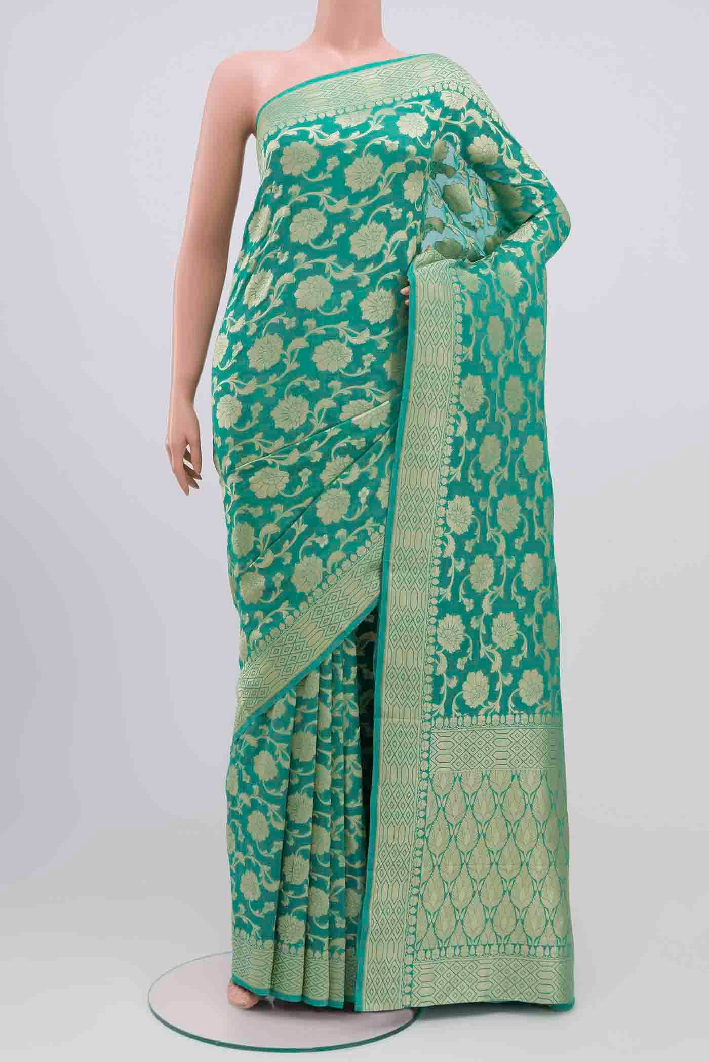 Mint Green Banarasi Georgette Saree with Zari Brocade on the body and Zari Border.  displayed on a mannequin