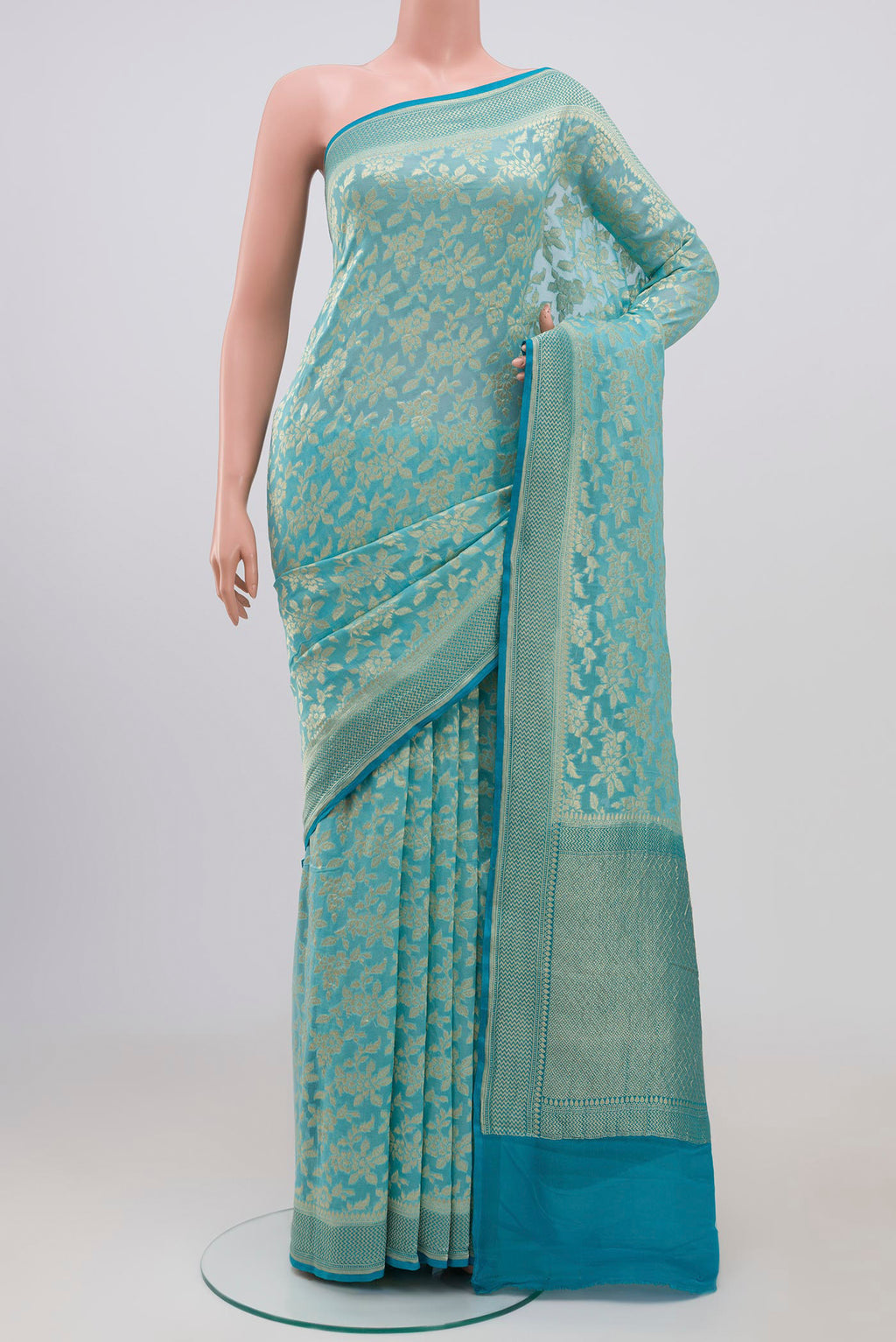 Sky Blue Banarasi Georgette Saree with Fancy on the body and Zari Border.  displayed on a mannequin