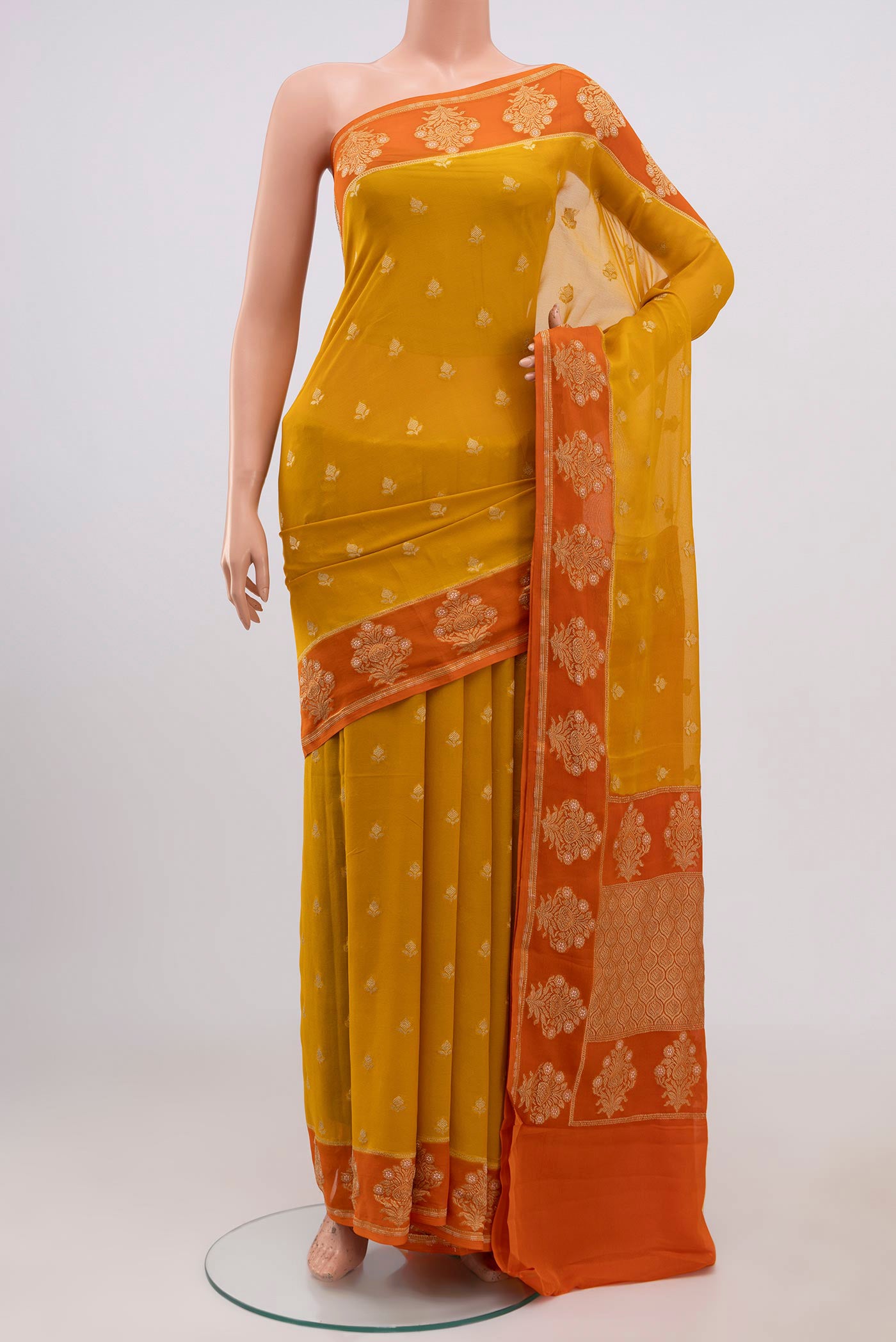 Yellow Banarasi Georgette Saree with Zari Butta on the body and Fancy Border.  displayed on a mannequin
