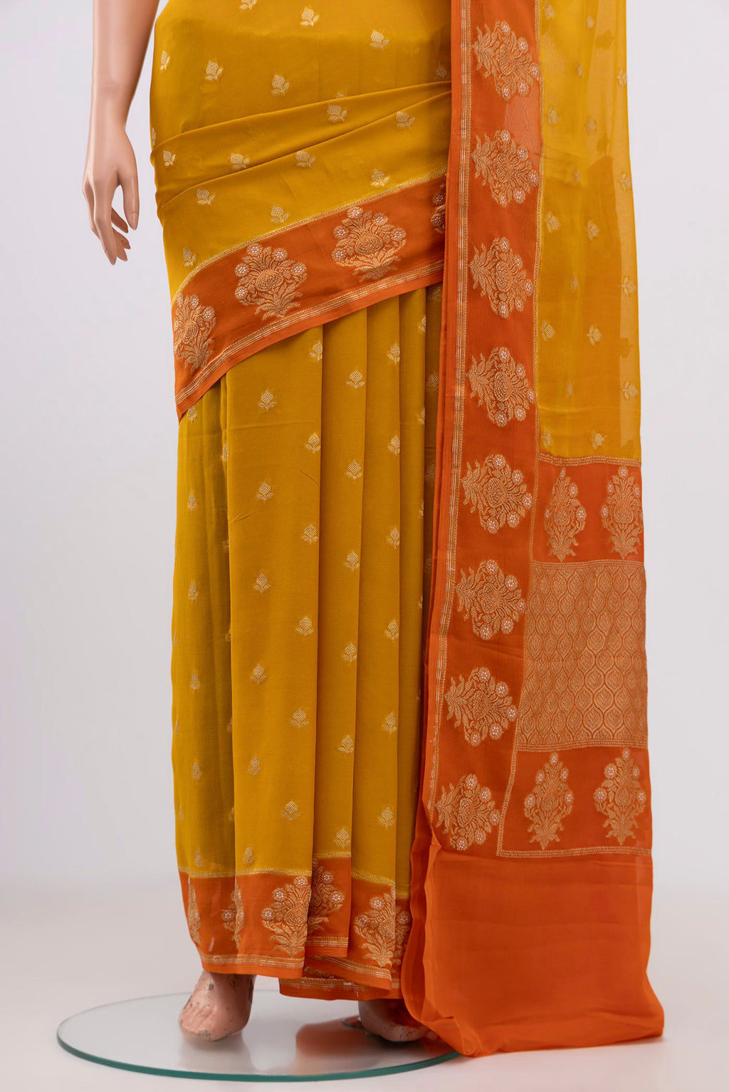 Pleats and pallu of Yellow Banarasi Georgette Saree with Zari Butta on the body and Fancy Border. 
