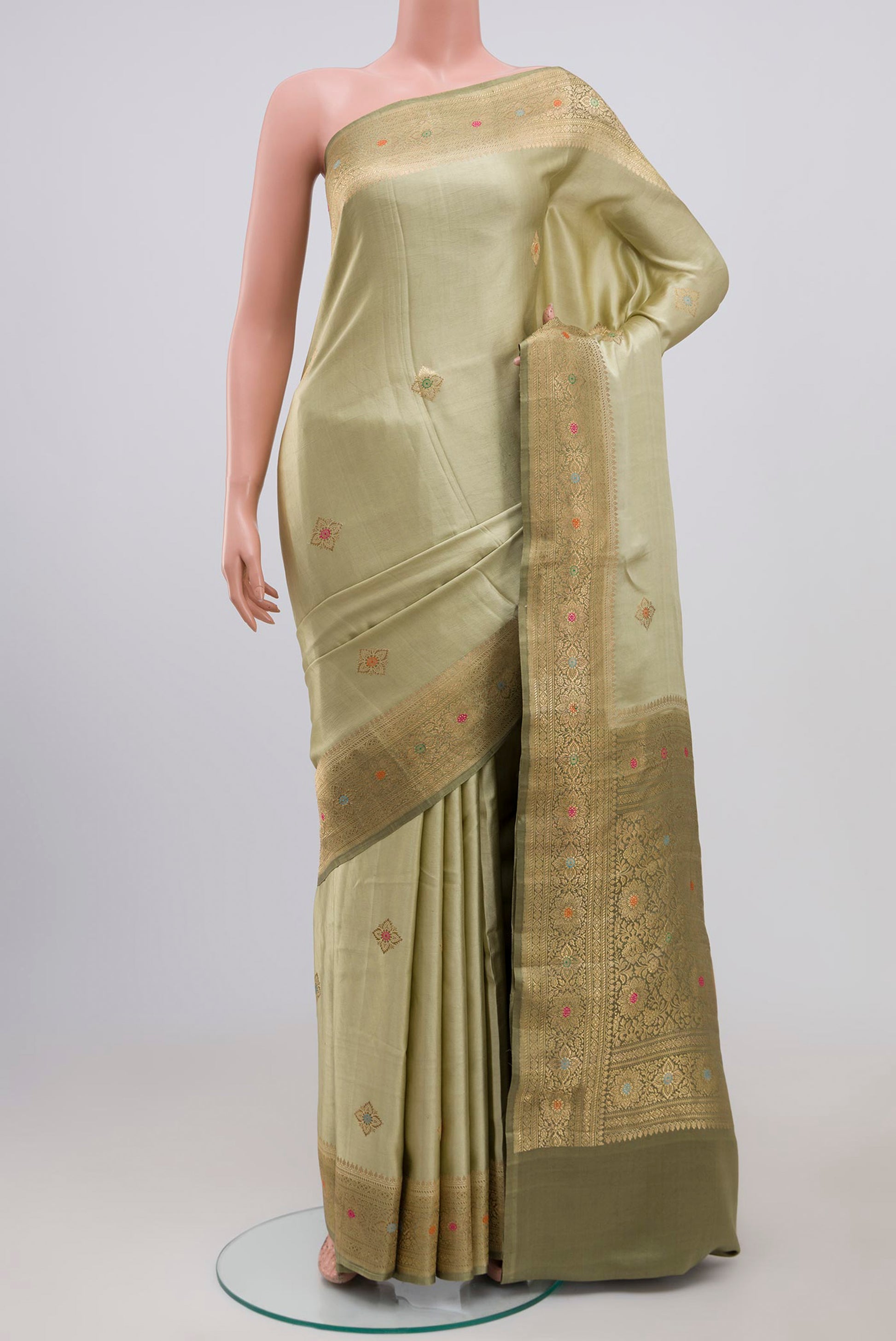 Pista Green Banarasi Silk Saree with Zari Butta on the body and Zari Border.  displayed on a mannequin