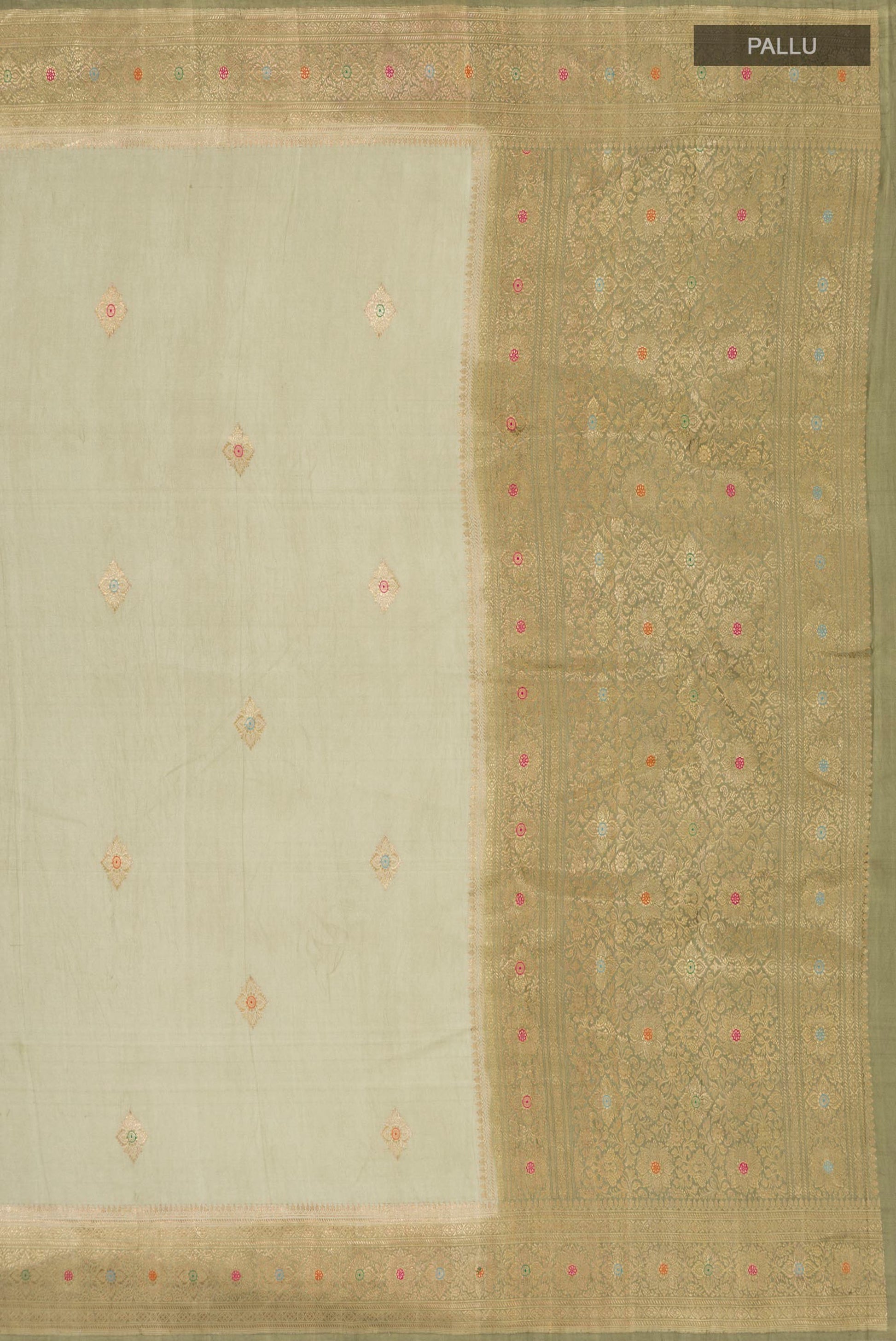 Close up image of the pallu of Pista Green Banarasi Silk Saree with Zari Butta on the body and Zari Border. 