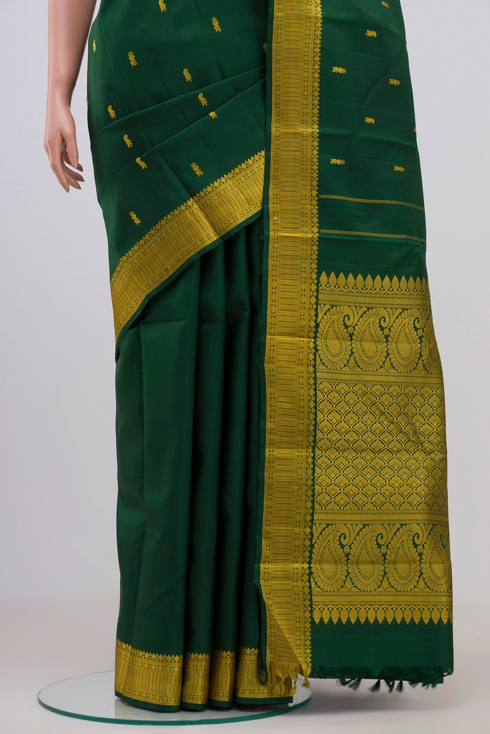 Pleats and pallu of Bottle Green Kanchipuram Silk Saree with Thread Butta on the body and Thread Border. 