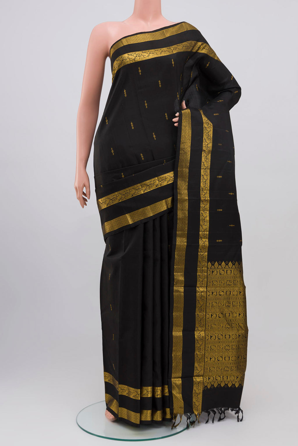 Black Kanchipuram Saree with Zari Butta on the body and Zari Border.  displayed on a mannequin