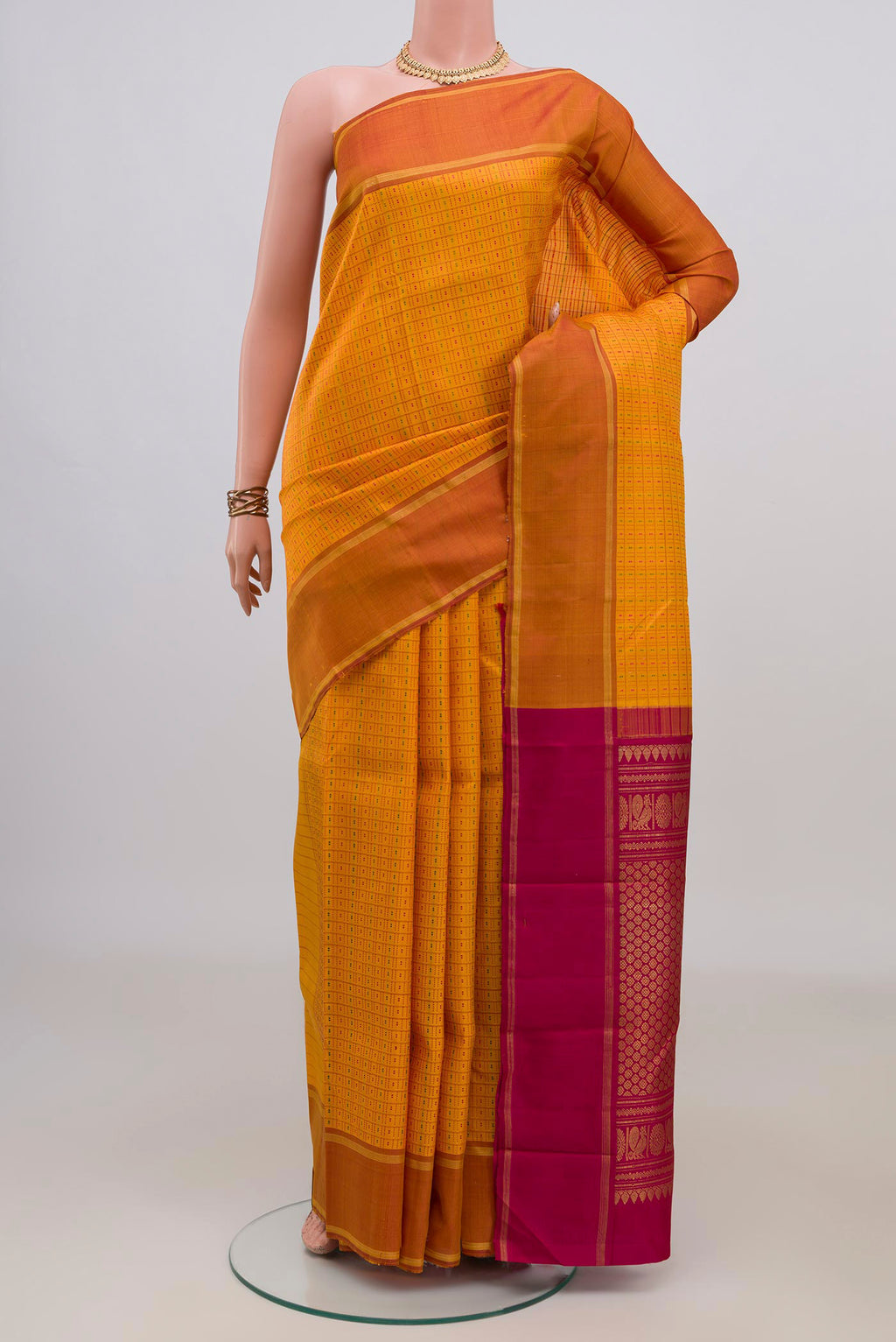 Pure Silk Yellow Kanchipuram Saree with Checked design on the body and Plain Border.  displayed on a mannequin