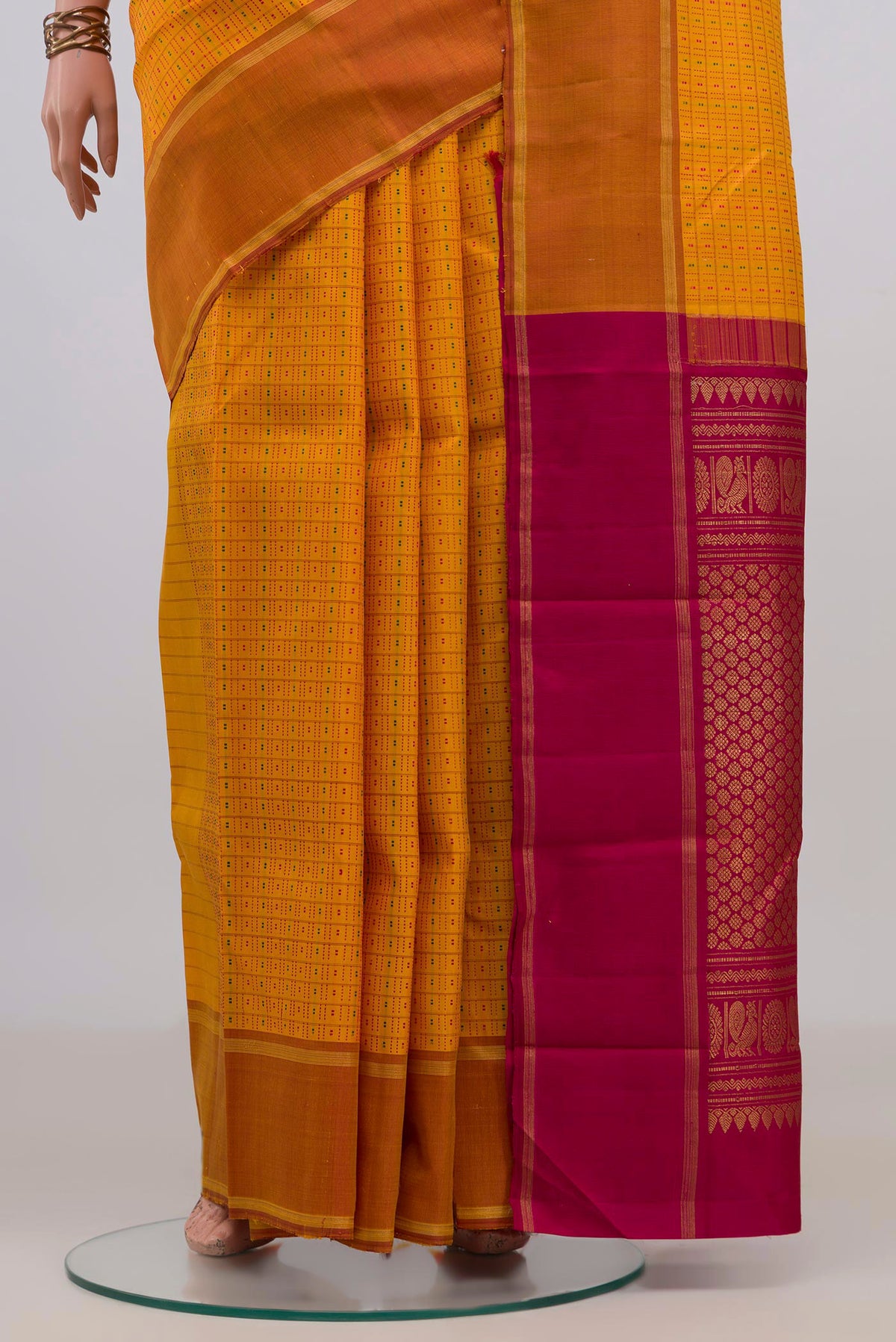 Pleats and pallu of Pure Silk Yellow Kanchipuram Saree with Checked design on the body and Plain Border. 