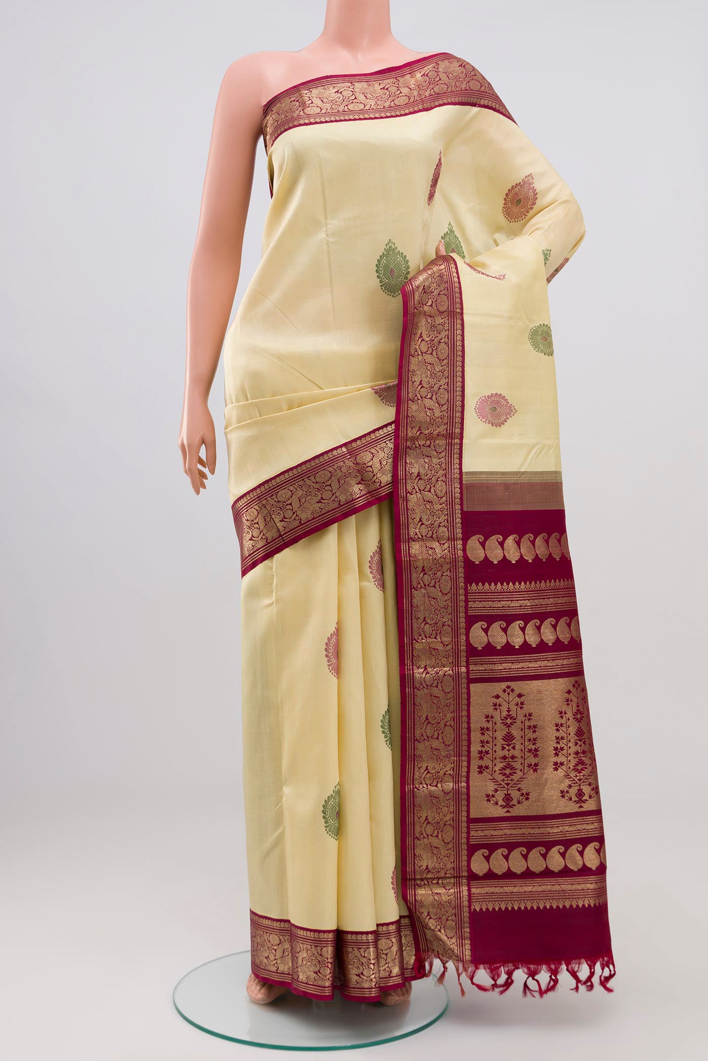 Pure Silk Pure Zari Cream Kanjivaram Saree with Zari Butta on the body and Zari Border.  displayed on a mannequin