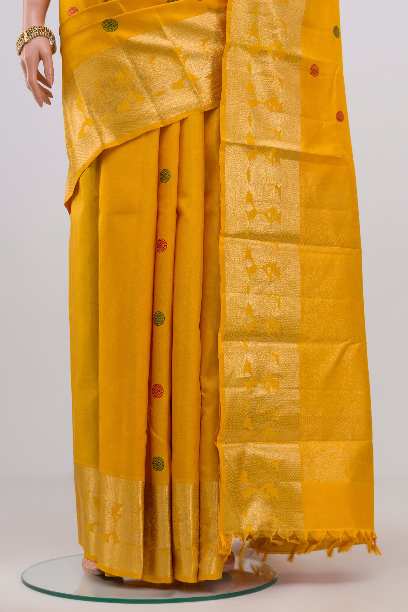 Pleats and pallu of Yellow Kanjivaram Silk Saree with Thread Butta on the body and Zari Border. 