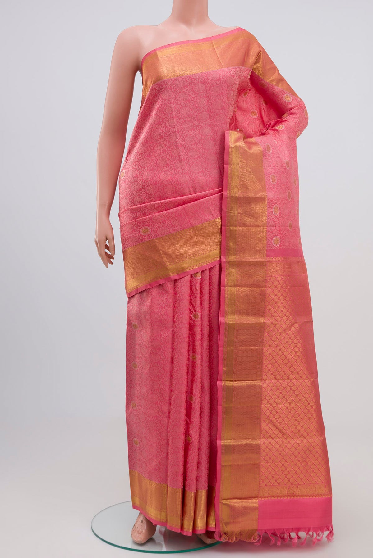Peach Kanjivaram Silk Saree with Jacquard With Zari Butta on the body and Zari Border.  displayed on a mannequin