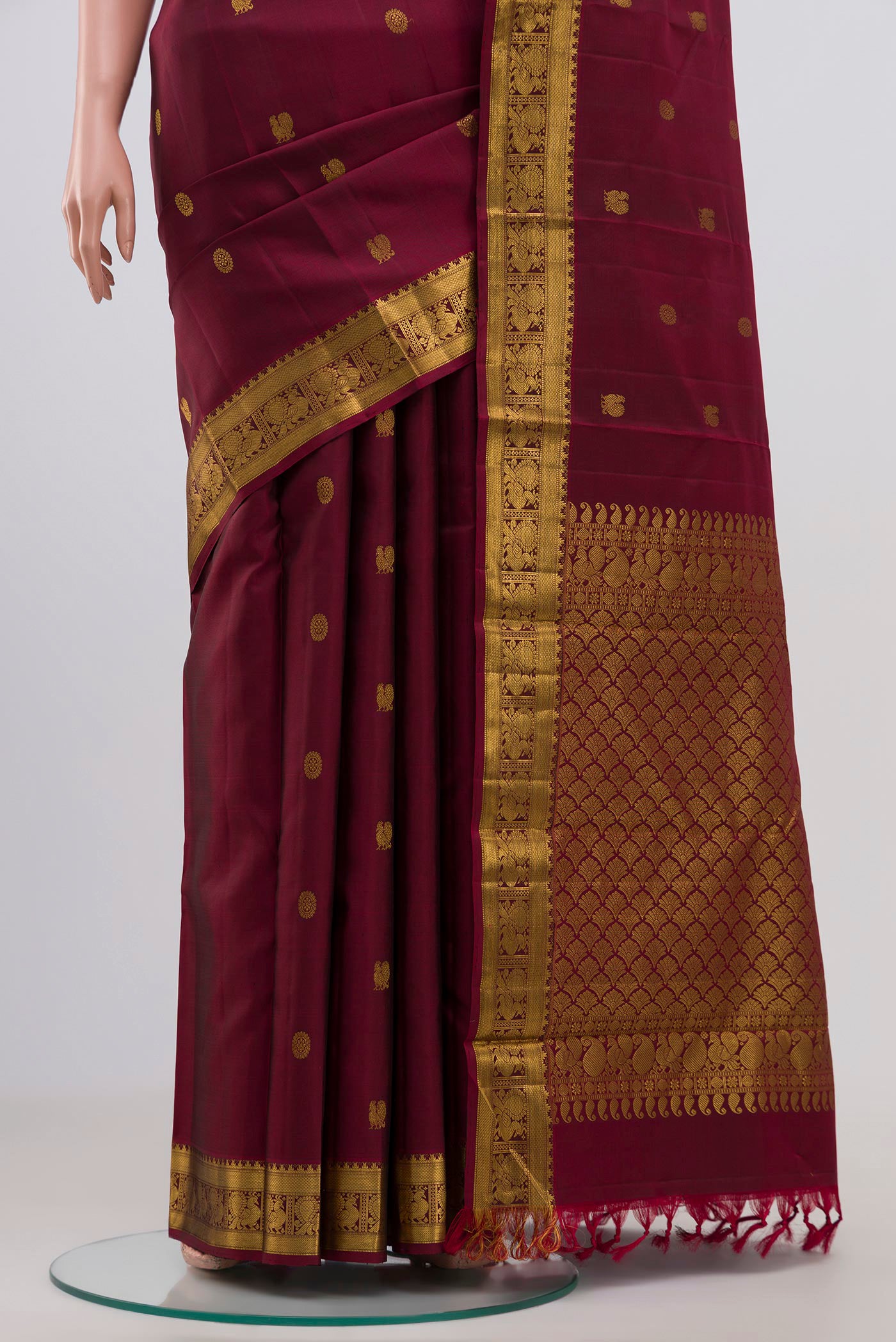Pleats and pallu of Maroon Kanjivaram Silk Saree with Zari Butta on the body and Zari Border. 