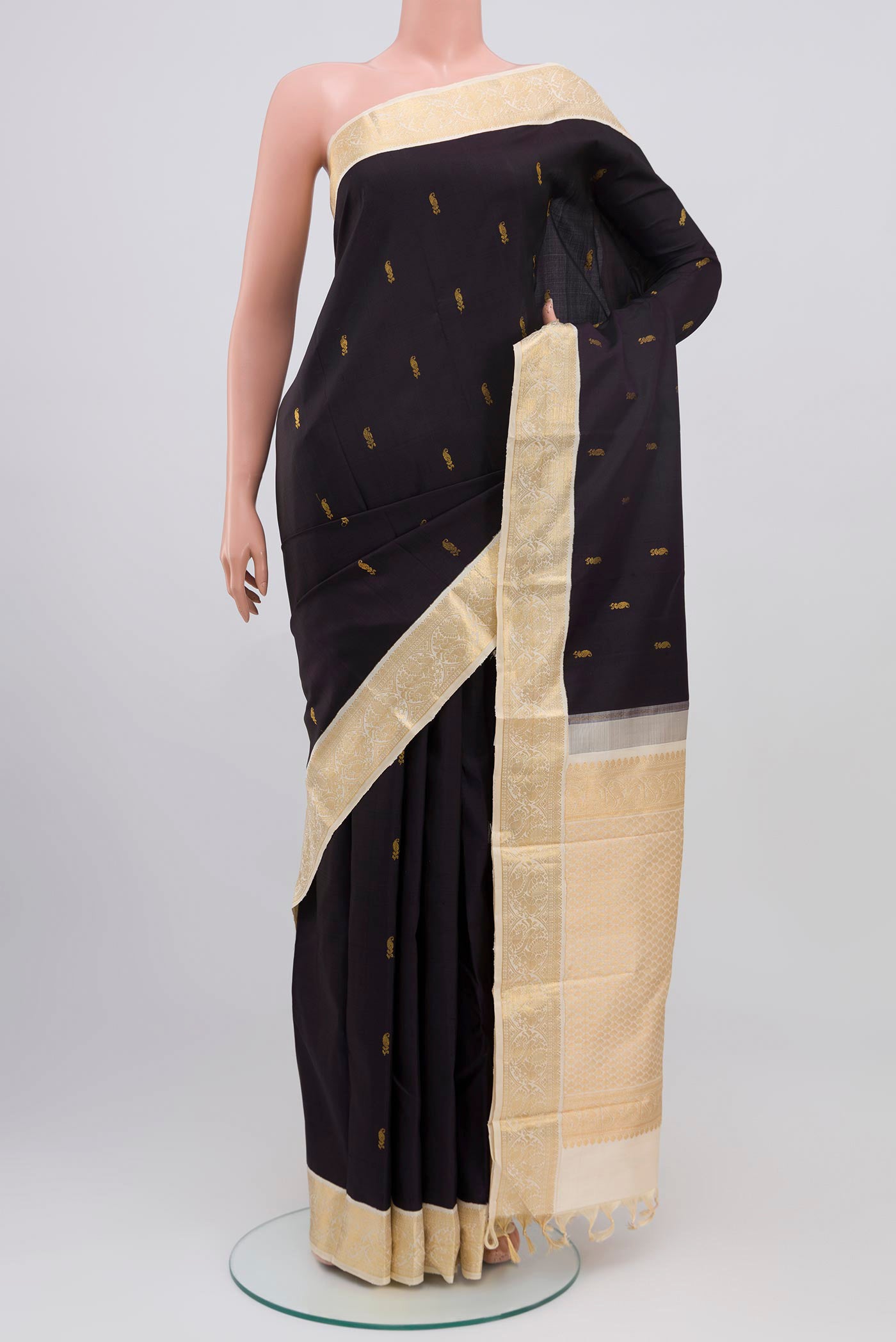 Black Kanjivaram Saree with Zari Butta on the body and Zari Border.  displayed on a mannequin