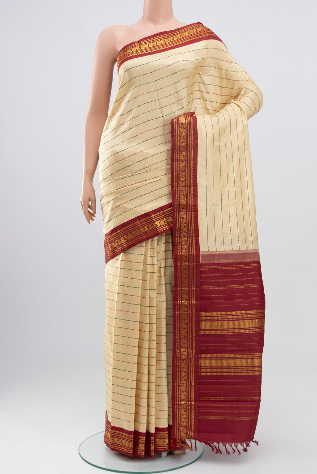 Pure Silk Pure Zari Cream Kanjivaram Saree with Veldhari on the body and Zari Border.  displayed on a mannequin