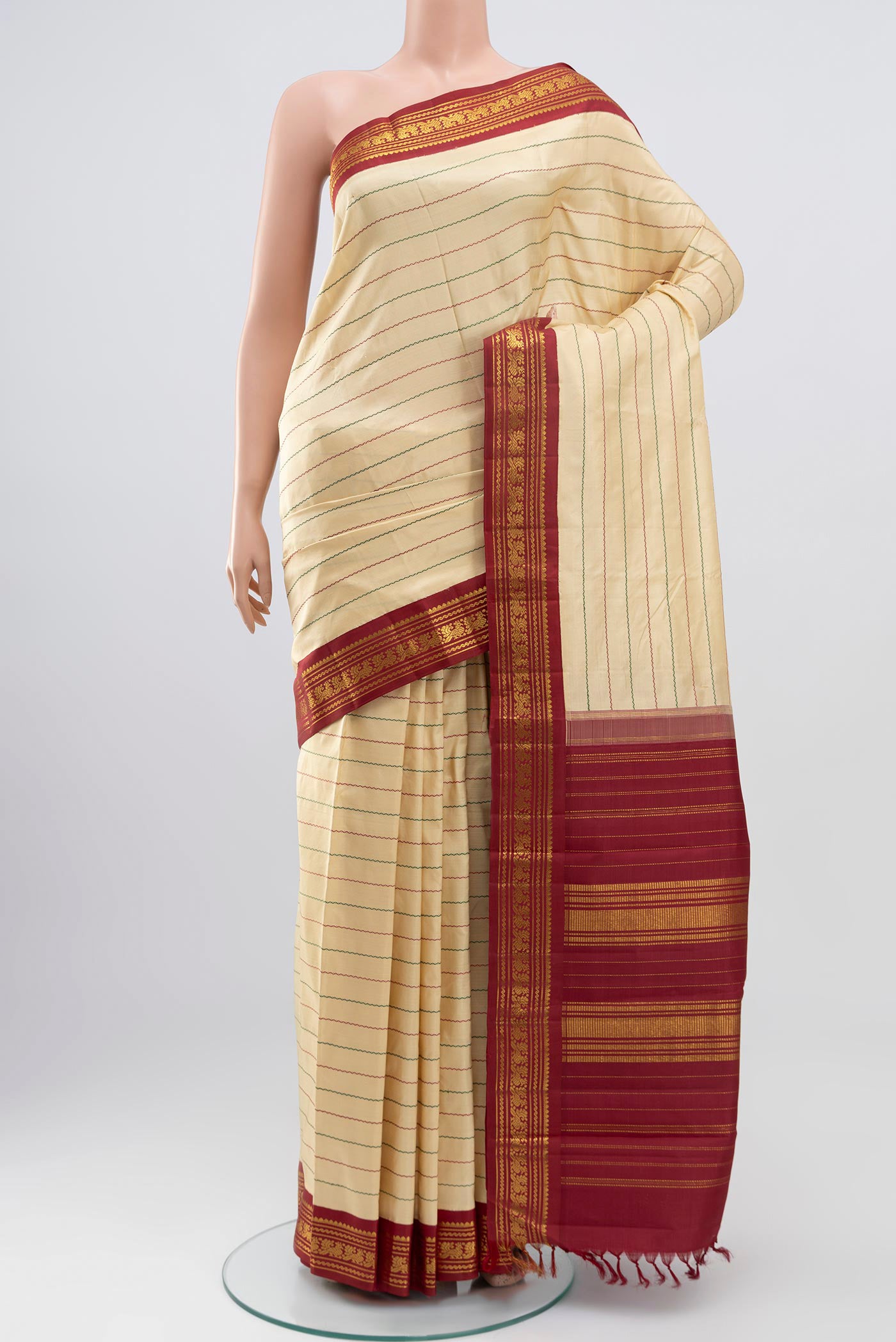 Pure Silk Pure Zari Cream Kanjivaram Saree with Veldhari on the body and Zari Border.  displayed on a mannequin