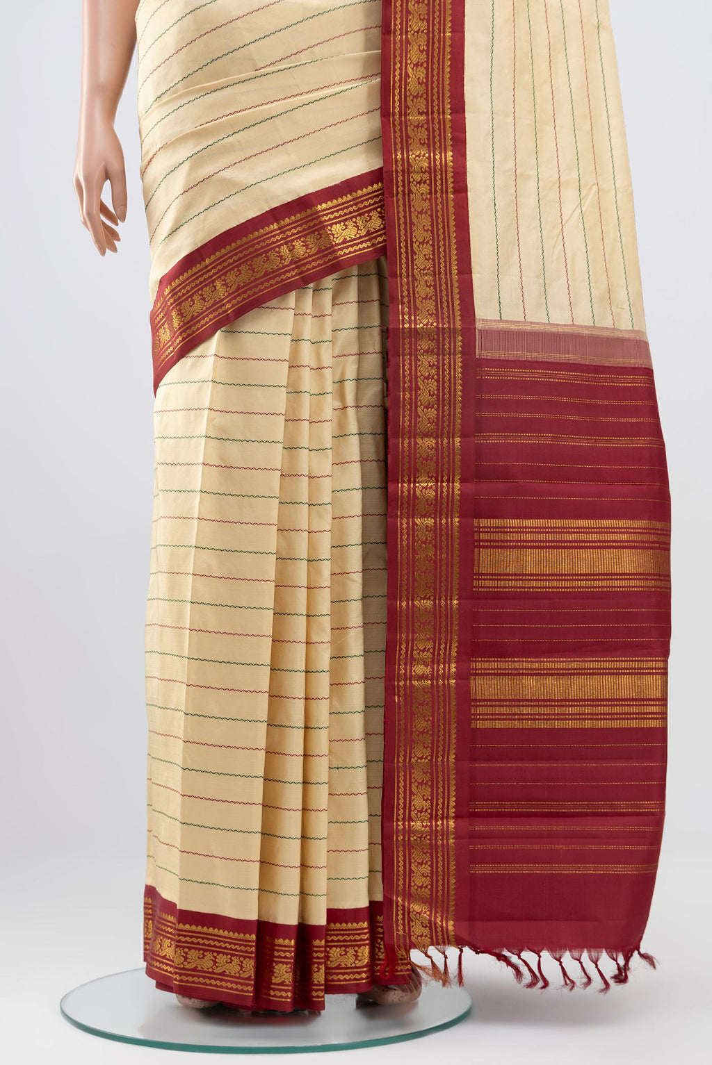 Pleats and pallu of Pure Silk Pure Zari Cream Kanjivaram Saree with Veldhari on the body and Zari Border. 
