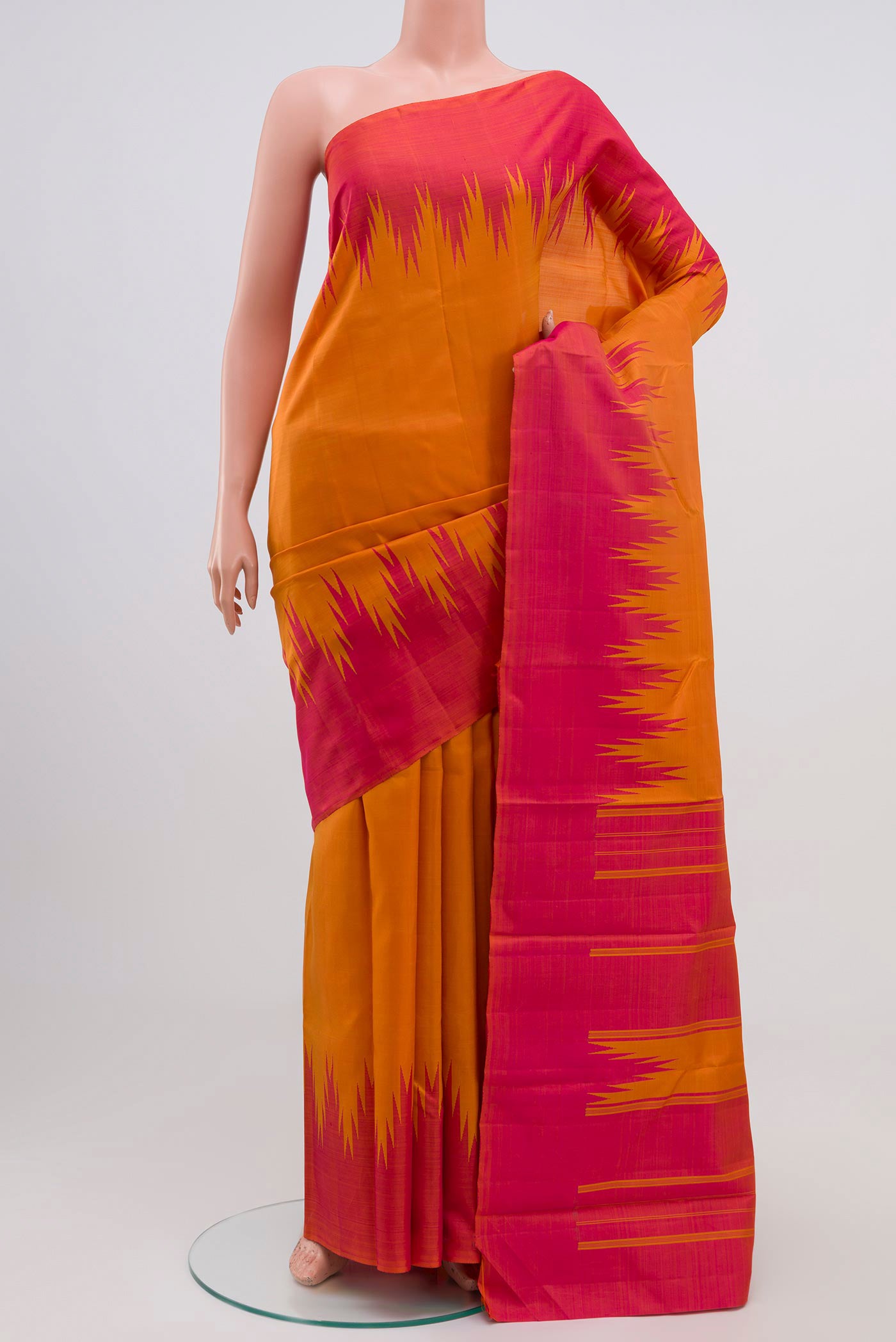 Mustard Kanchipuram Silk Saree with Plain Body and Temple Border.  displayed on a mannequin
