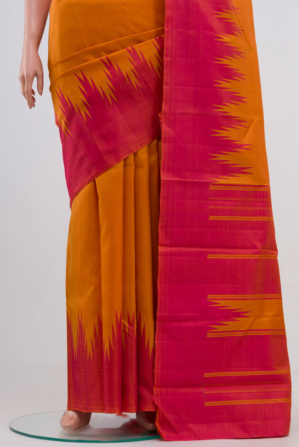 Pleats and pallu of Mustard Kanchipuram Silk Saree with Plain Body and Temple Border. 