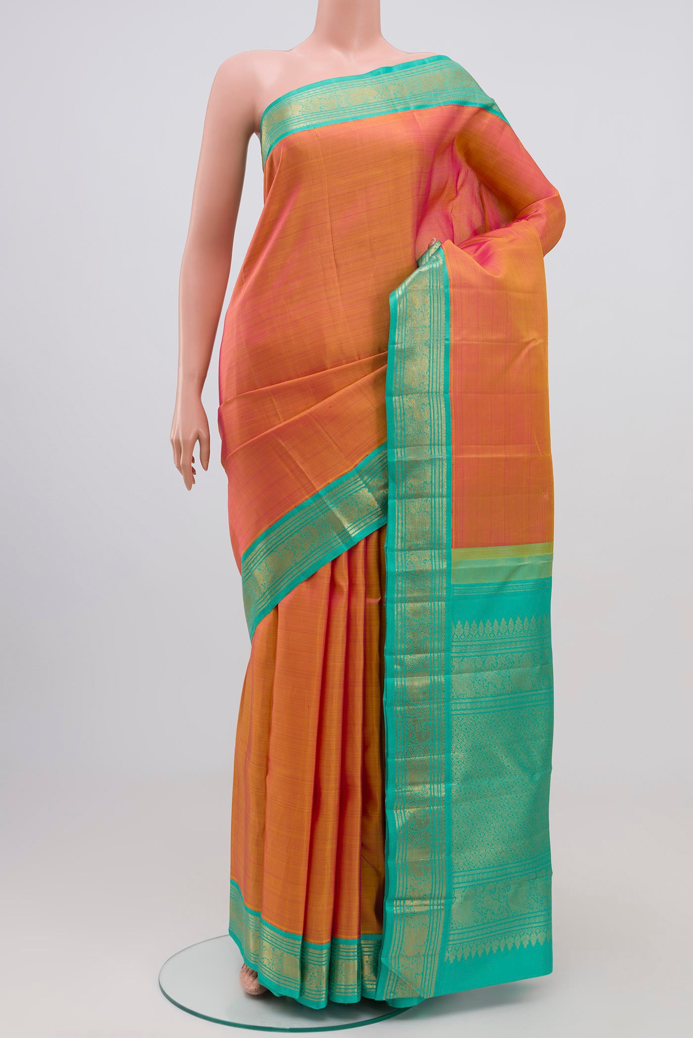 Pure Silk Pure Zari Orange Dual Tone Kanjivaram Saree with Plain Body and Zari Border.  displayed on a mannequin