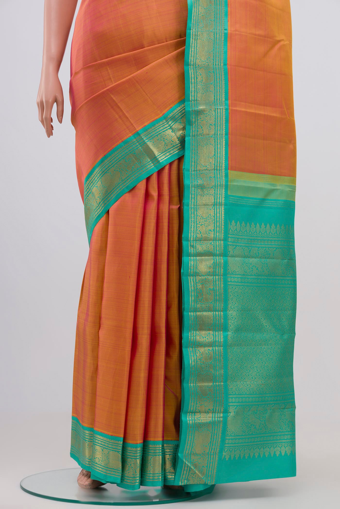 Pleats and pallu of Pure Silk Pure Zari Orange Dual Tone Kanjivaram Saree with Plain Body and Zari Border. 