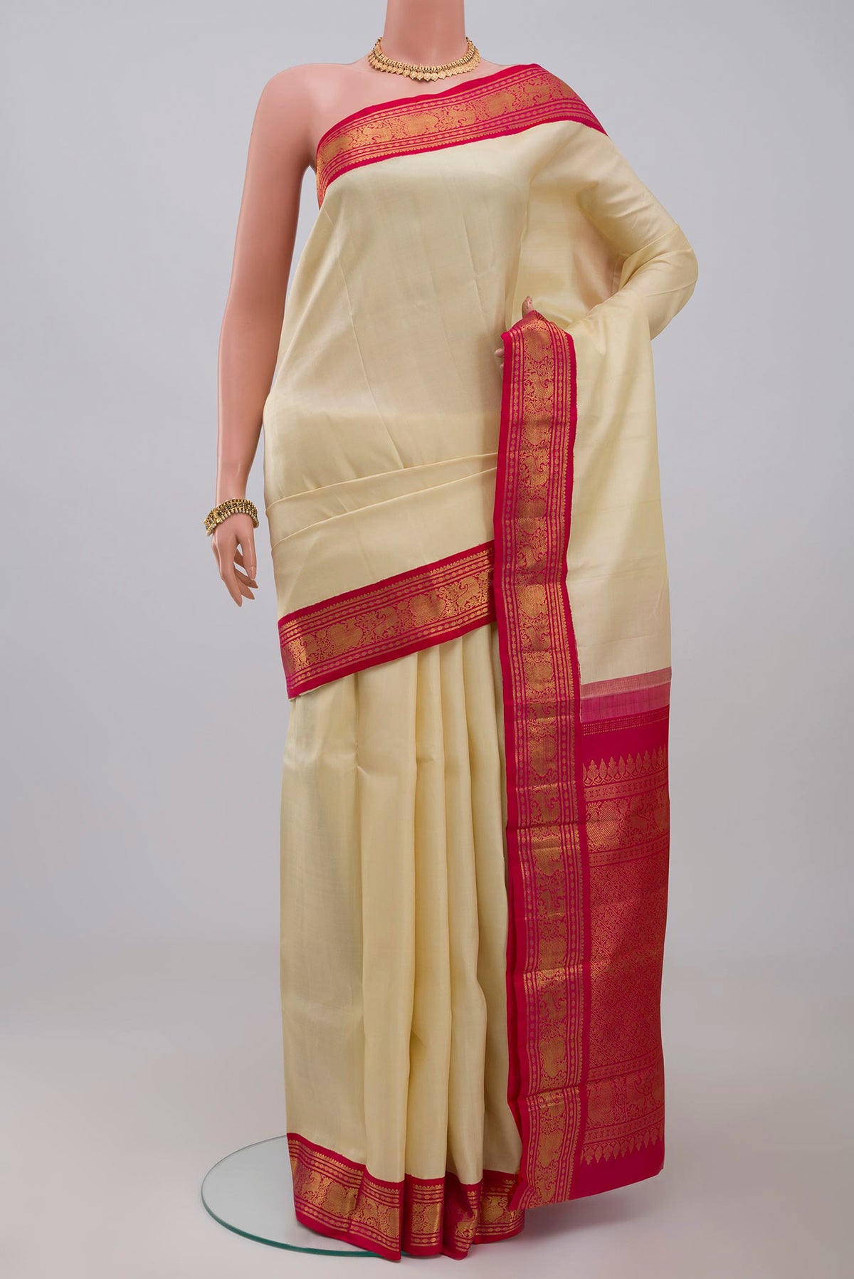 Pure Silk Pure Zari Cream Kanjivaram Saree with Plain Body and Zari Border.  displayed on a mannequin