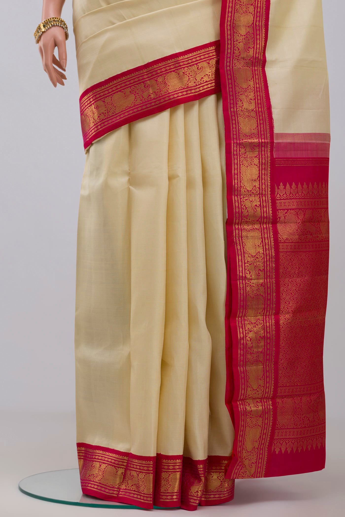 Pleats and pallu of Pure Silk Pure Zari Cream Kanjivaram Saree with Plain Body and Zari Border. 