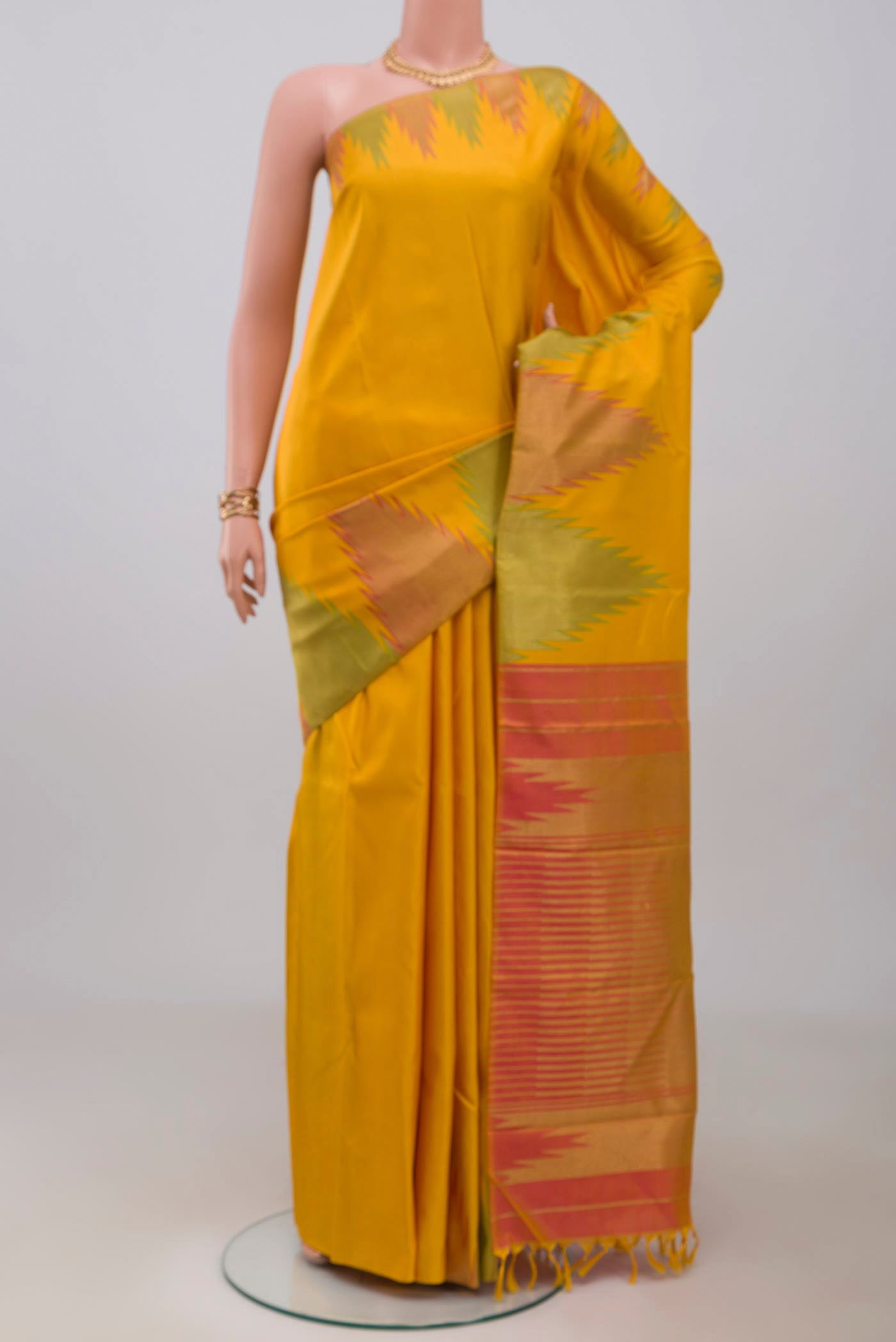Pure Silk Pure Zari Yellow Kanjivaram Saree with Plain Body and Temple Border.  displayed on a mannequin
