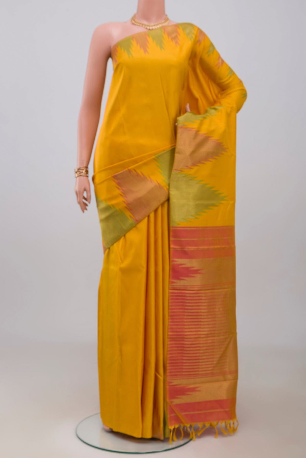 Pure Silk Pure Zari Yellow Kanjivaram Saree with Plain Body and Temple Border.  displayed on a mannequin