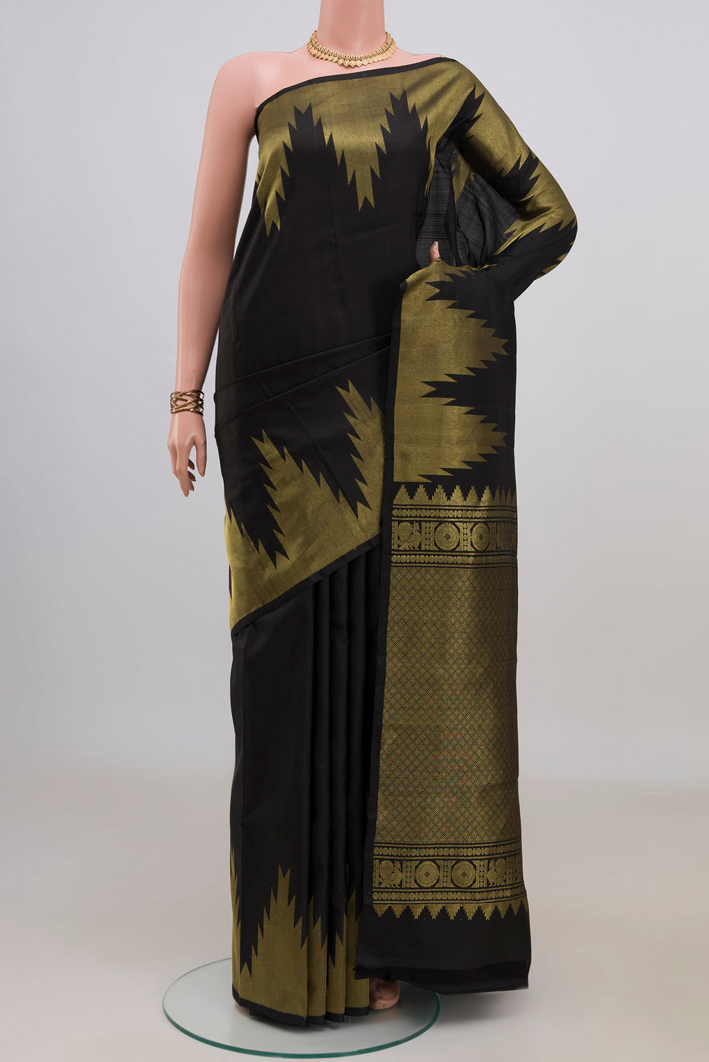 Pure Silk Black Kanchipuram Saree with Plain Body and Temple Border.  displayed on a mannequin